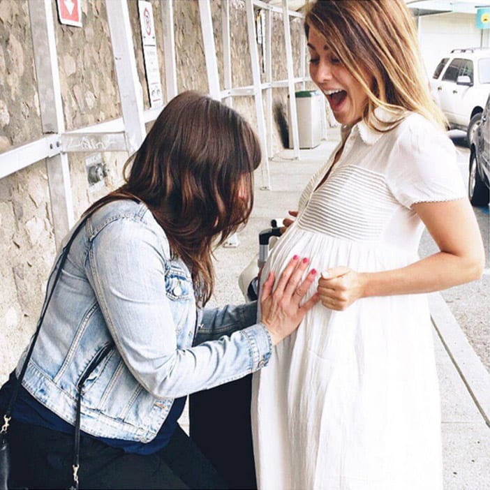 Karissa kissing baby bump in Aritzia dress