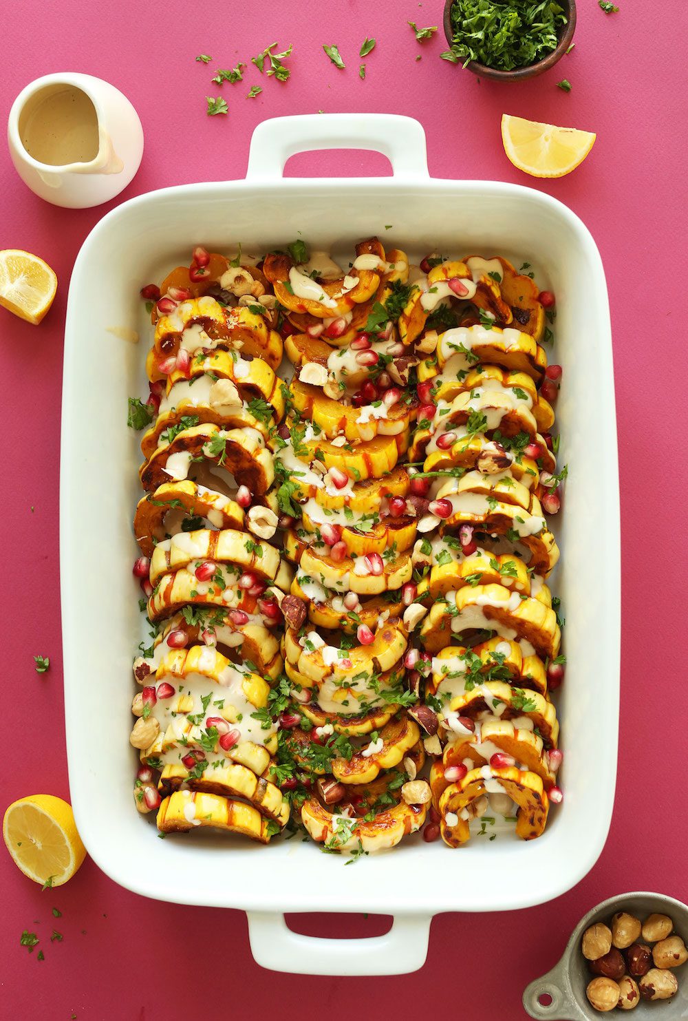 amazing-delicata-squash-bake-with-hazelnuts-pomegranates-and-tahini-sauce-recipe-vegan-glutenfree-thanksgiving-fall-minimalistbaker