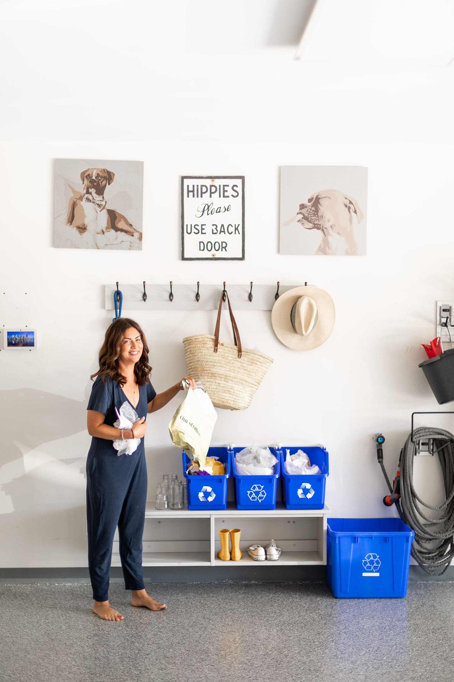 Jillian Harris sorting recycling items to their proper bins in the garage