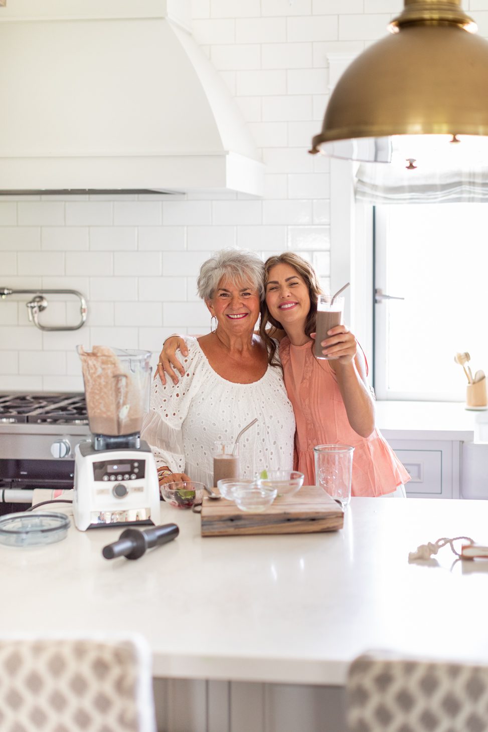 Jillian and mom smiling and holding smoothie 