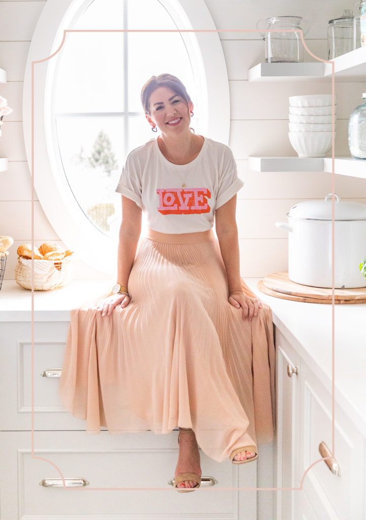 Jillian Harris sitting in pantry looking at camera smiling