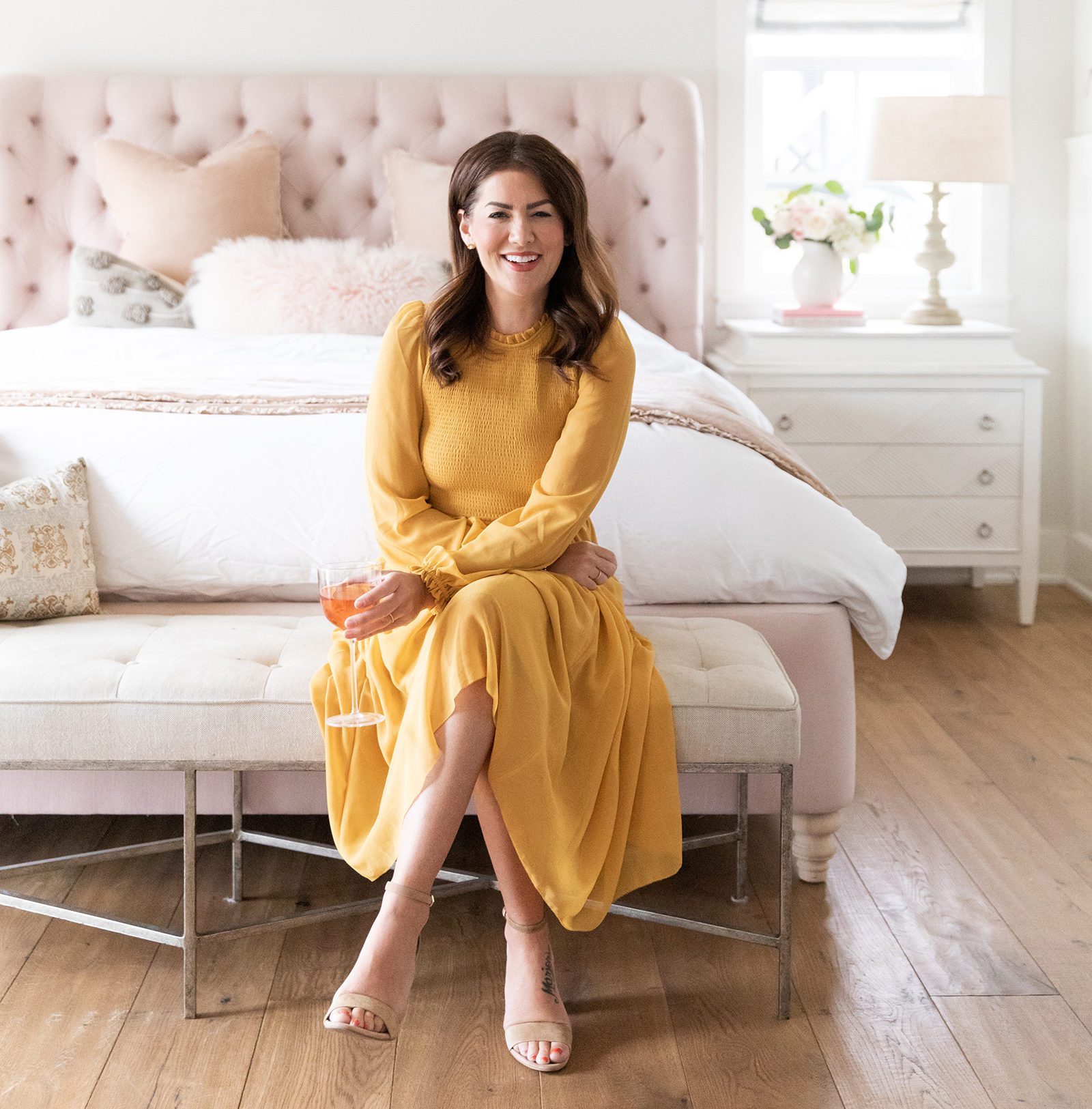 Jillian Harris sitting at end of bed