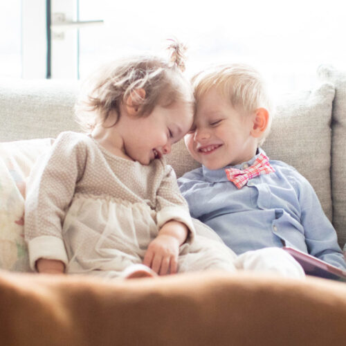 Annie and Leo cuddling on the couch