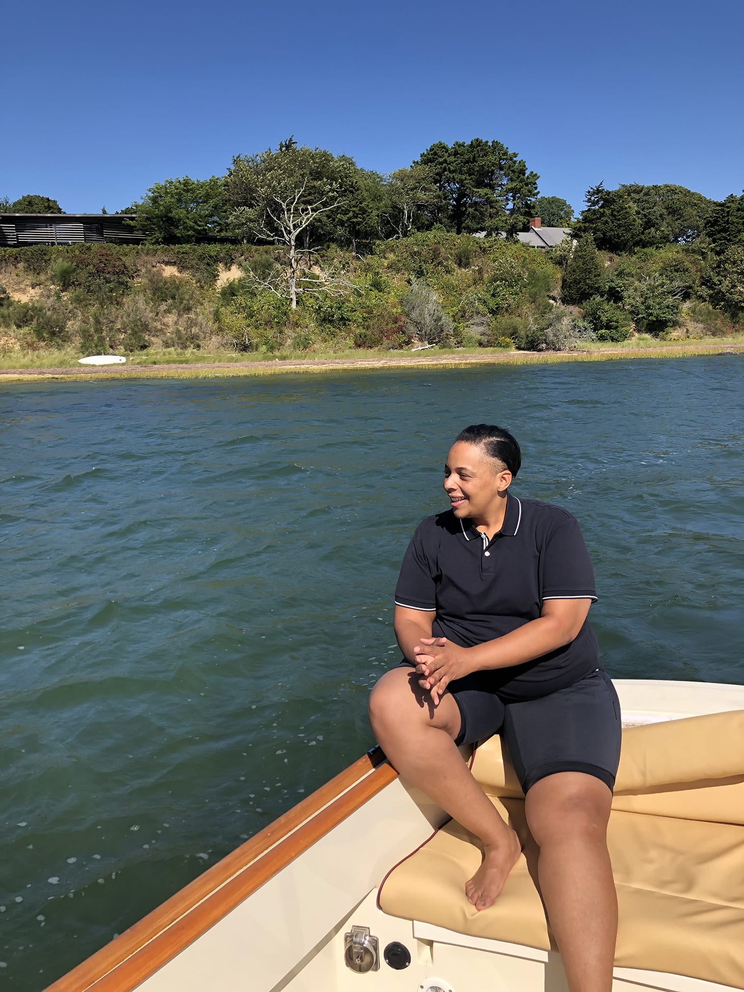 Health and Wellness coach, Coach Carey on a boat on a lake.