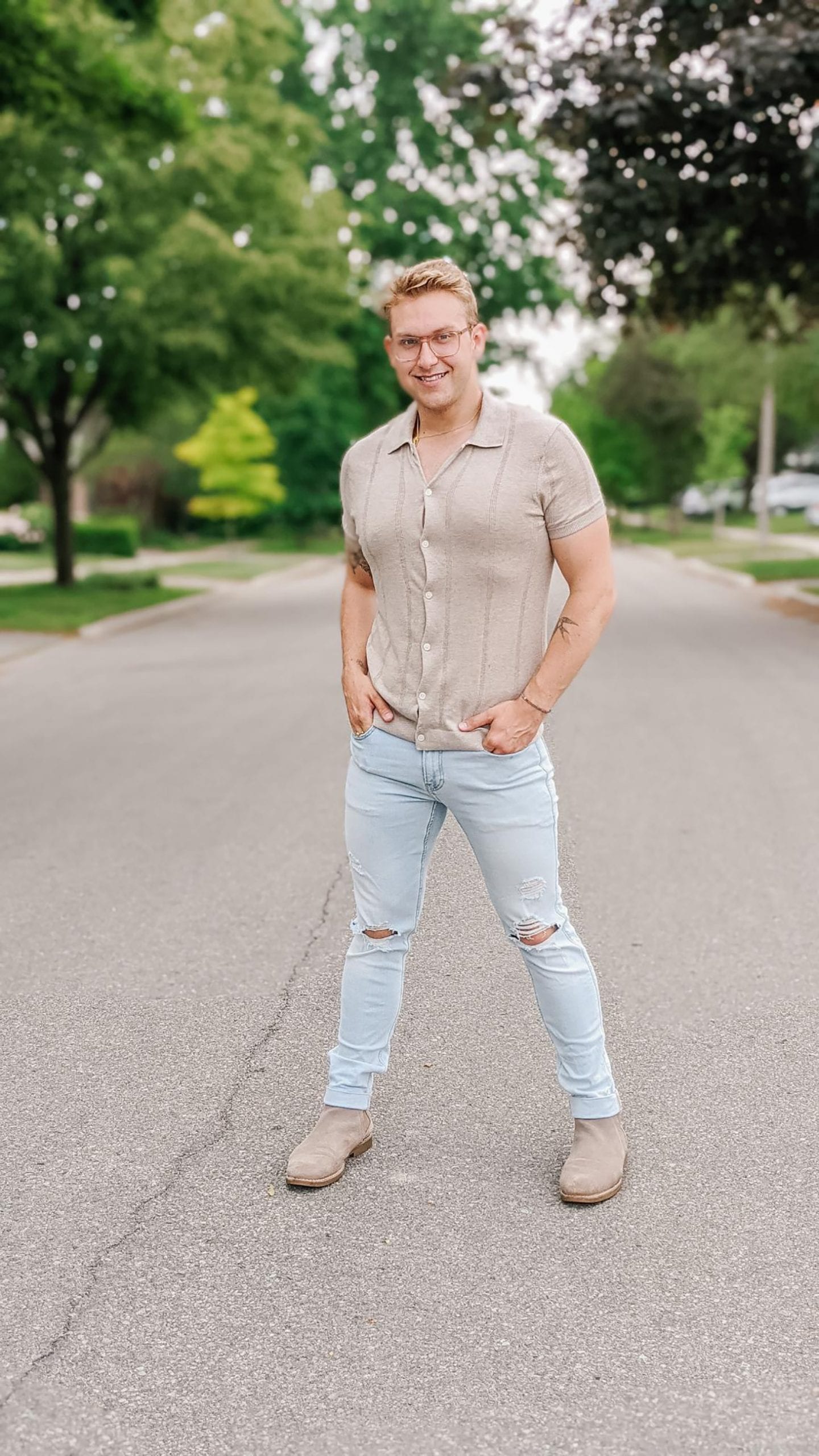 Christoper Allen standing in the middle of a quiet residential street wearing one of his Summer Inspired Outfits.