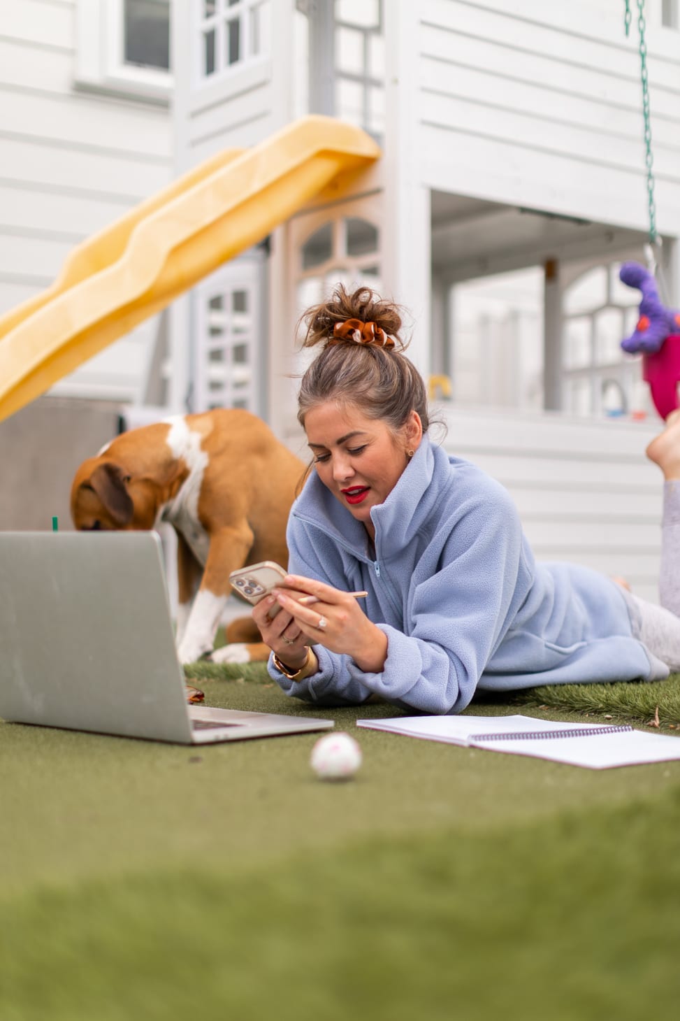 Jillian Harris working on The Jilly Academy at home at her children's playground over the summer. 