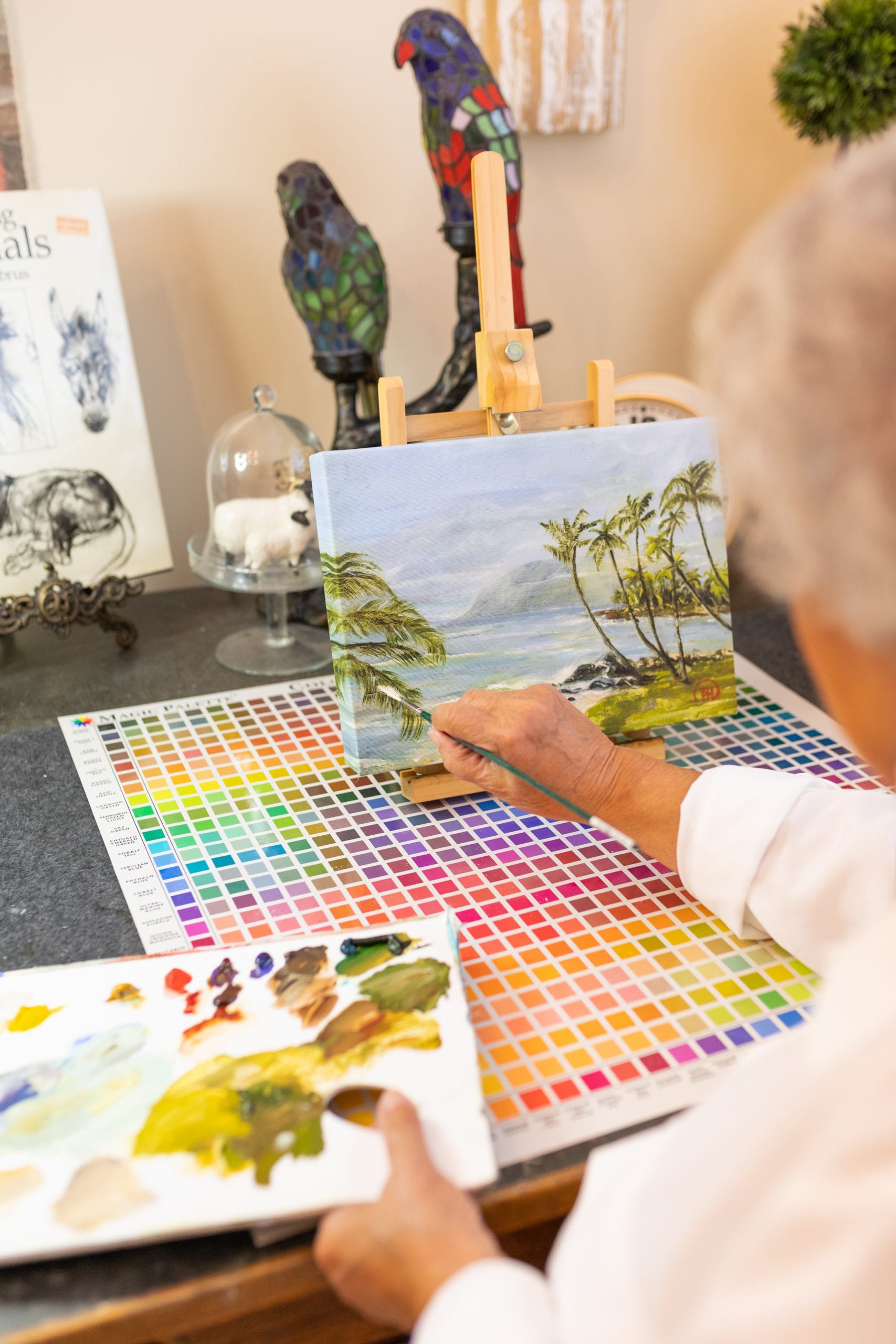 Peggy Harris getting back into painting by painting a tropical scene.