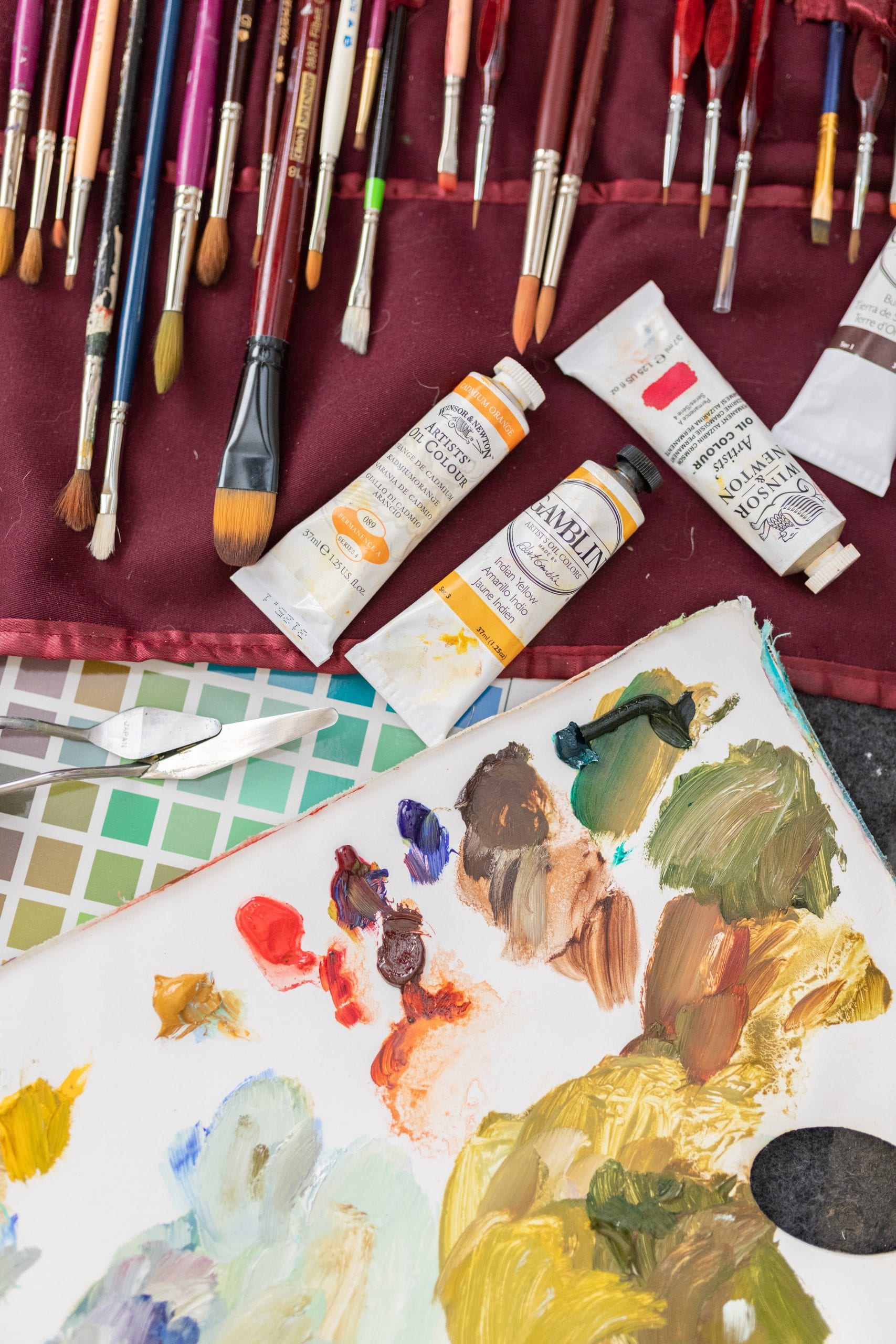 Peggy's paint brushes, mixing palette, and a few tubes of oil paint colours.