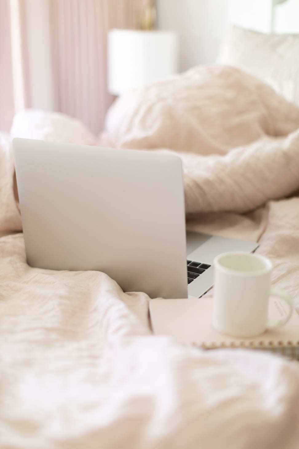 Jillian Harris' laptop and coffee in her bed working on The Jilly Academy in the summer. 