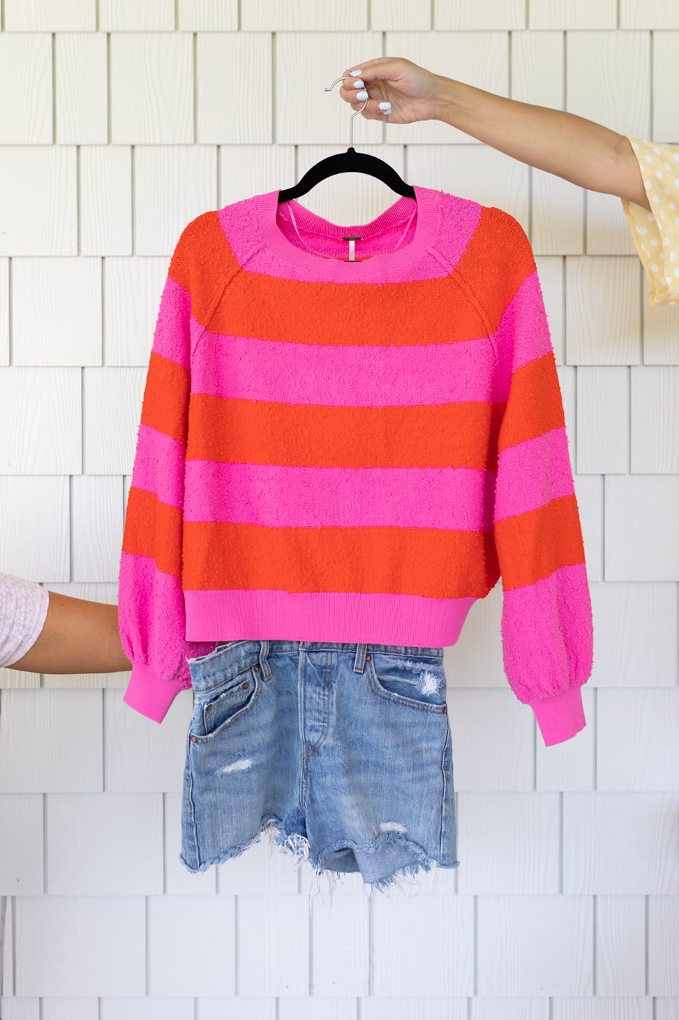 Jillian Harris' New Favourite Denim Shorts shown paired with with a light sweater with pink and red horizontal stripes.