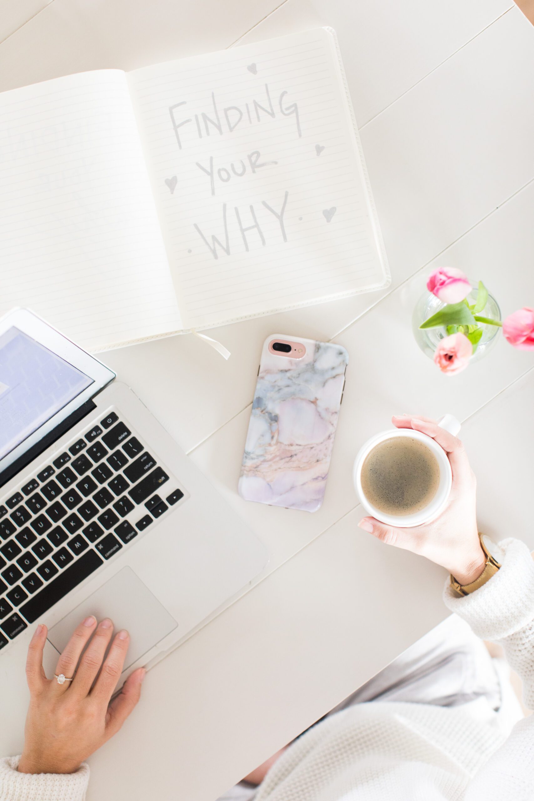 Jillian Harris' laptop, phone, coffee, and notebook that says "finding your why". Ready for Fall Semester at The Jilly Academy!