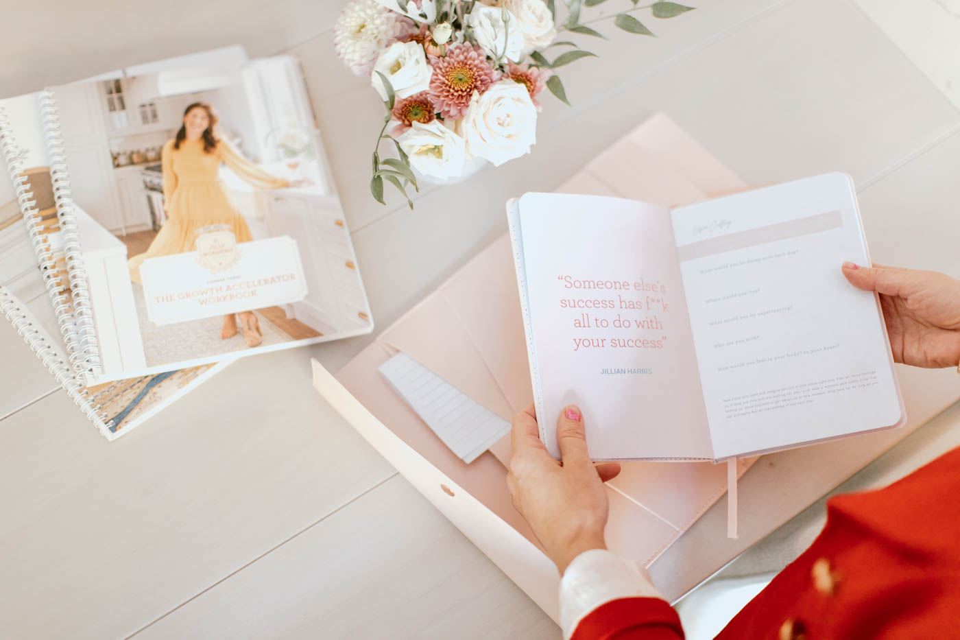 Jillian Harris overlooking The Jilly Academy Goals Planner, a product featured in The Jilly Academy Box. 