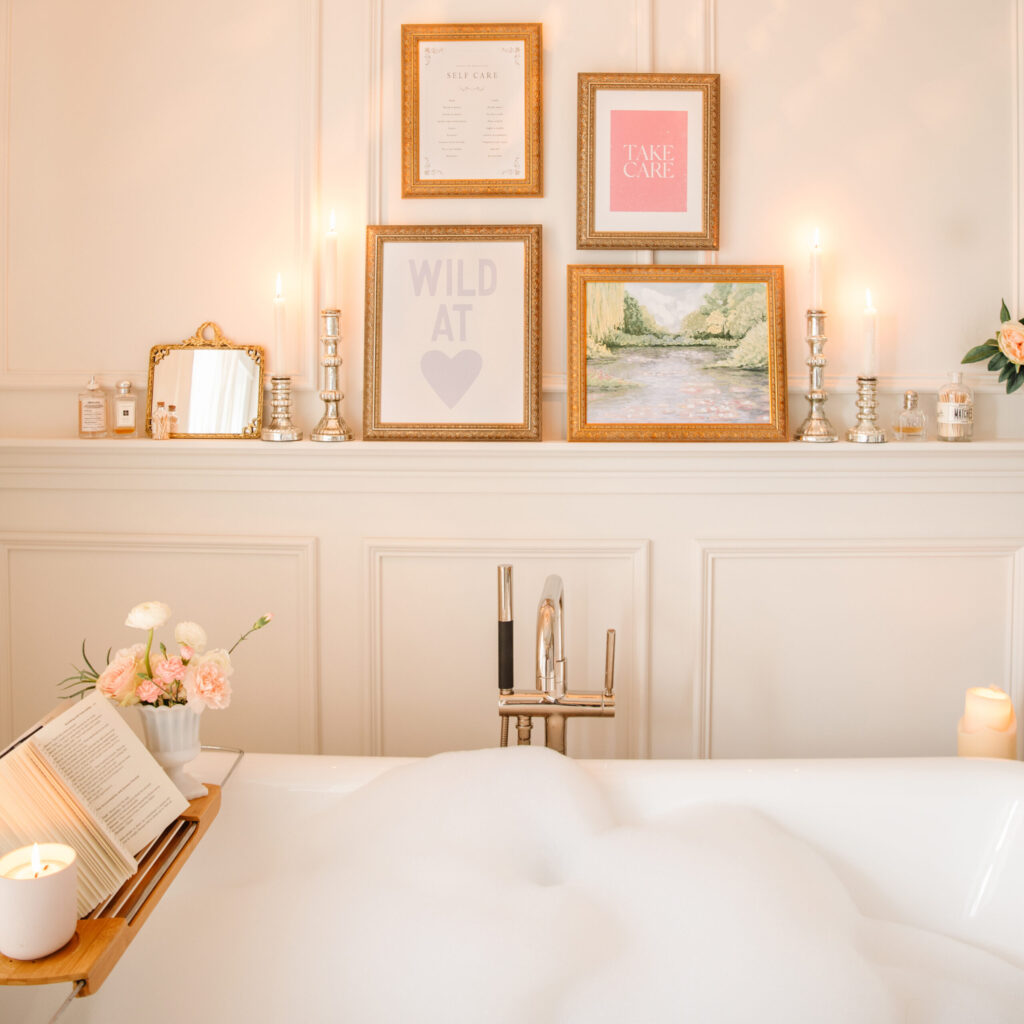 Jilly Digital framed prints above a filled bubble bath surrounded by candles