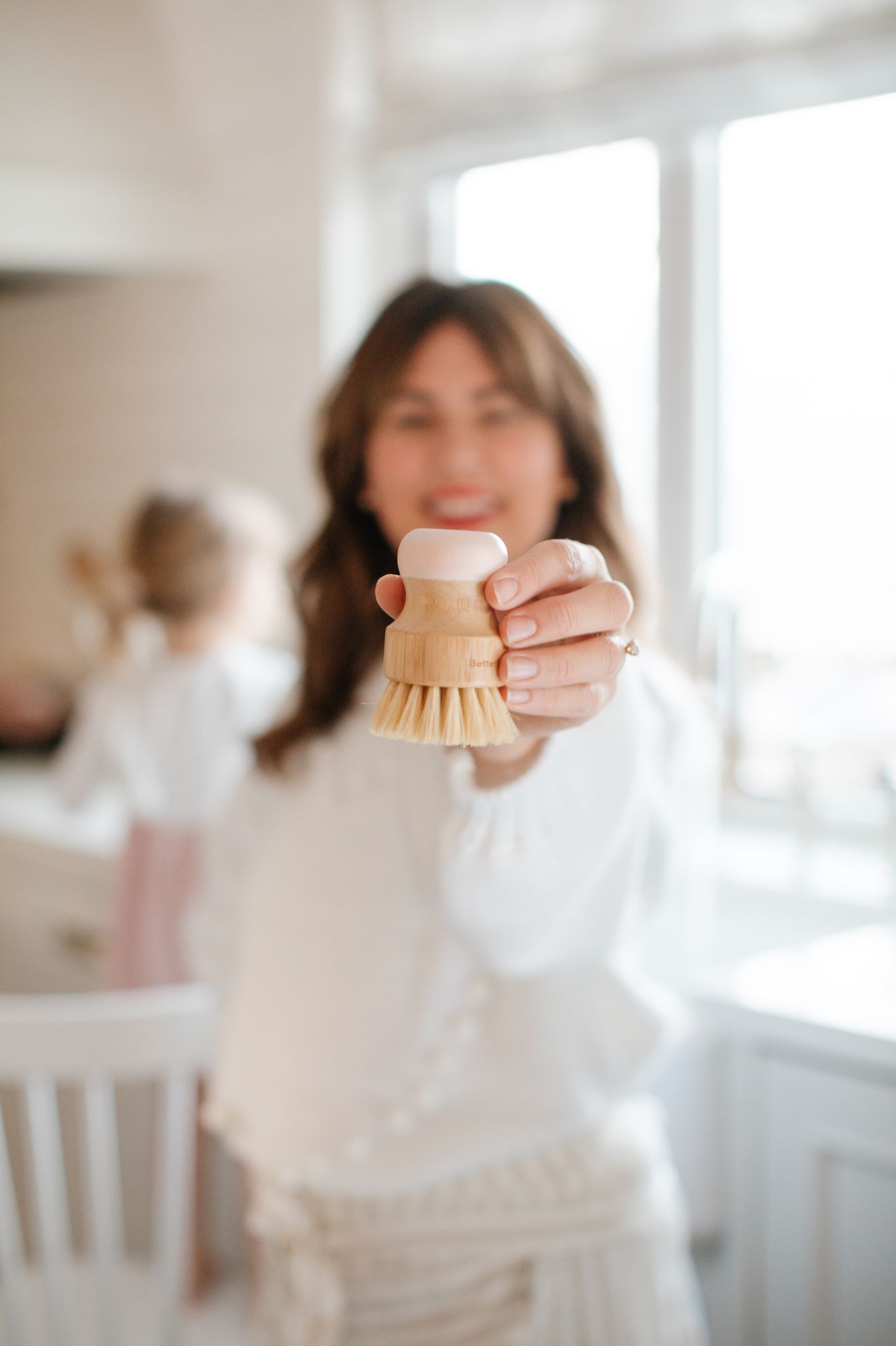 Jillian Harris holding the Better Basics Bristle Brush included in the Spring 2022 Jilly Box