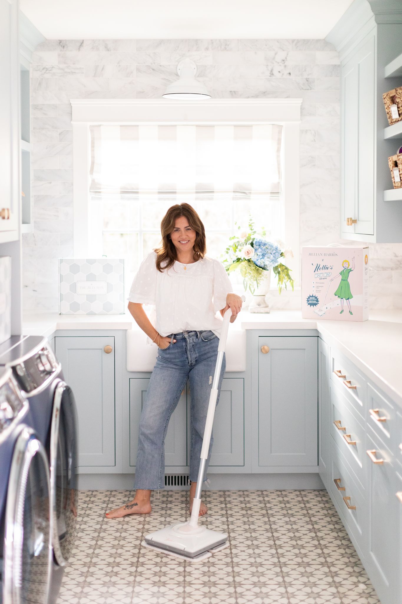 Jillian Harris posing with the Nellie's WOW Mop in Jilly Pink that is available in the Spring 2022 Jilly Box