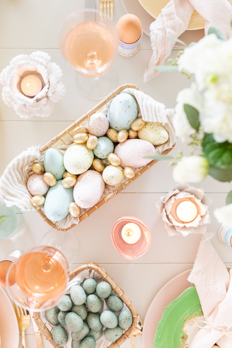 Overhead shot of a variety of Easter Eggs including chocolate, painted, and candy