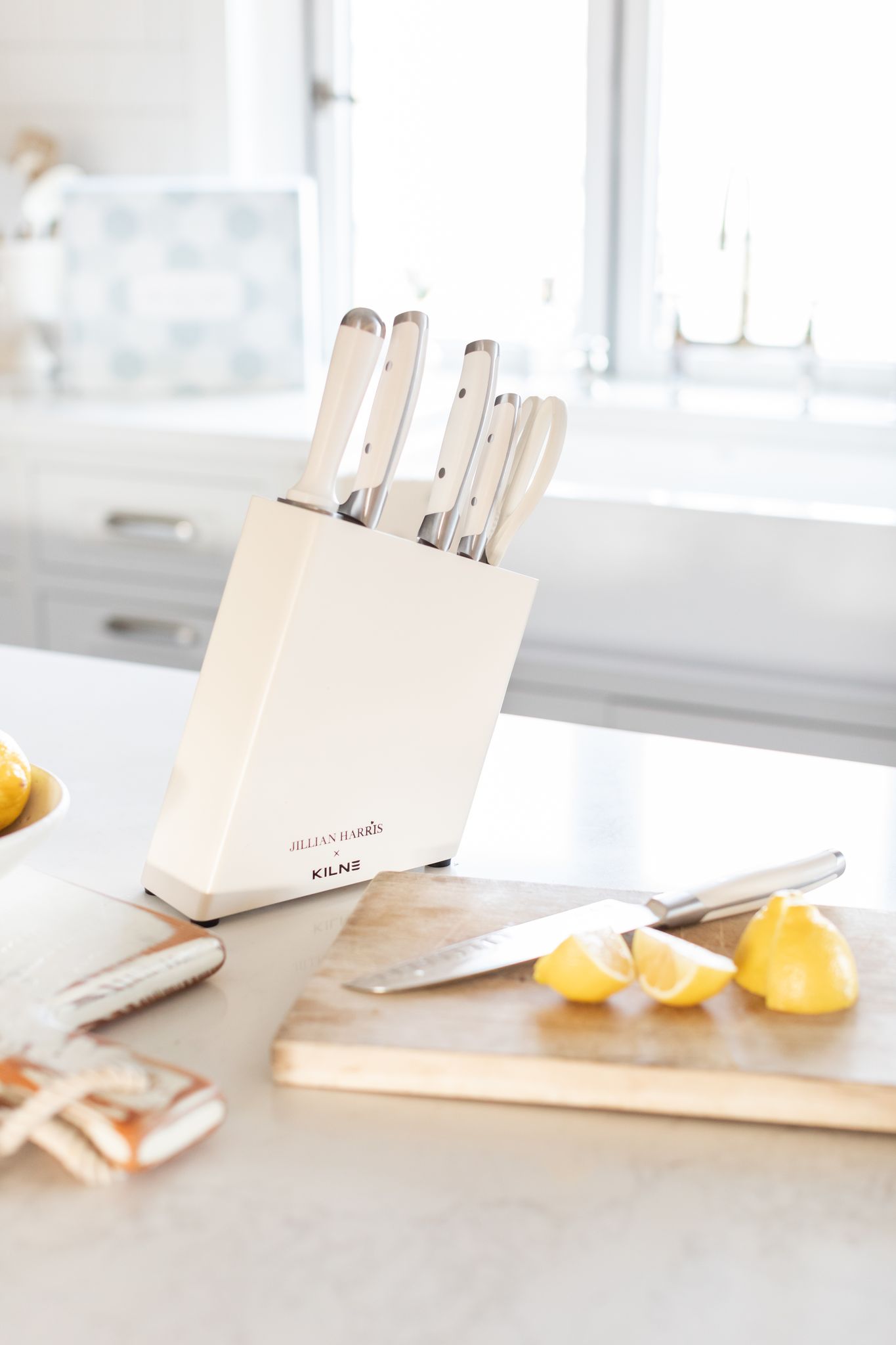 The Kilne Knife set displayed on Jillian Harris' kitchen island with lemons cut around it to show the add-on option for the Spring 2022 Jilly Box