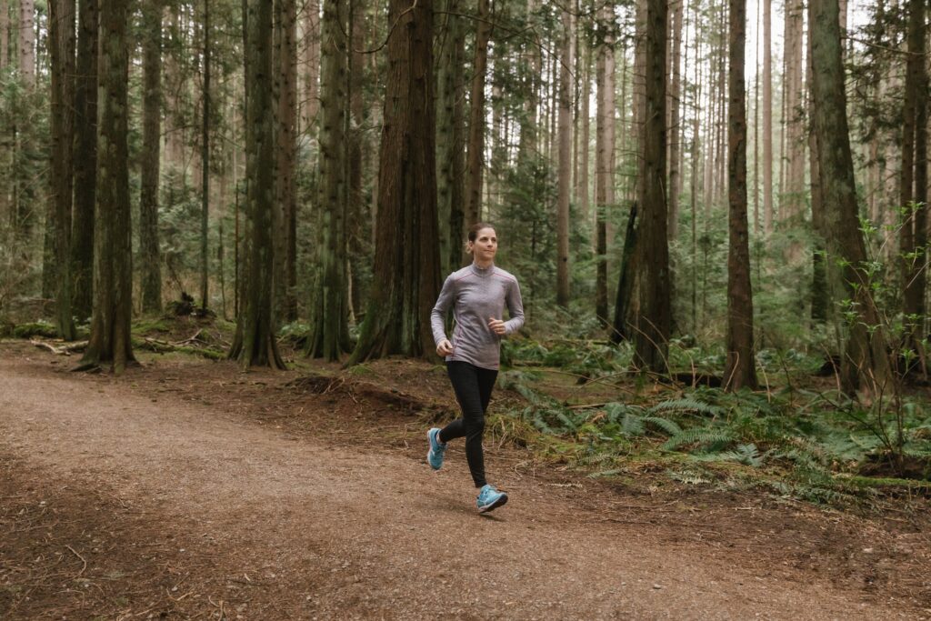 Christine Bergeron, President and CEO of Vancity running on forest path