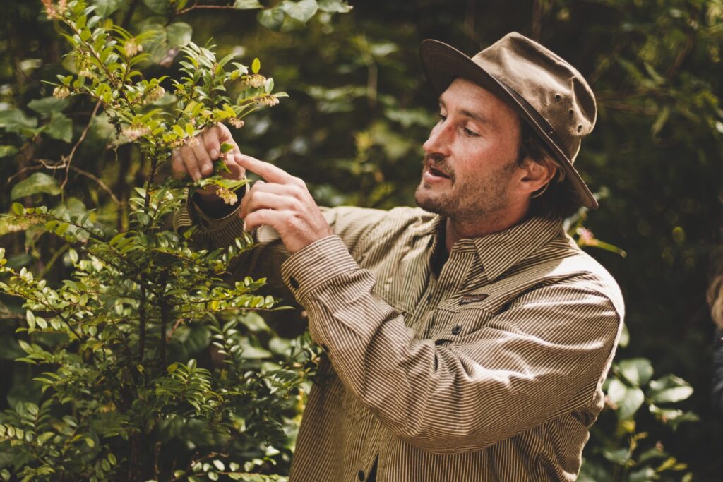 Ross Reid pointing at plants and discussing Biodiversity and Ecological Impact