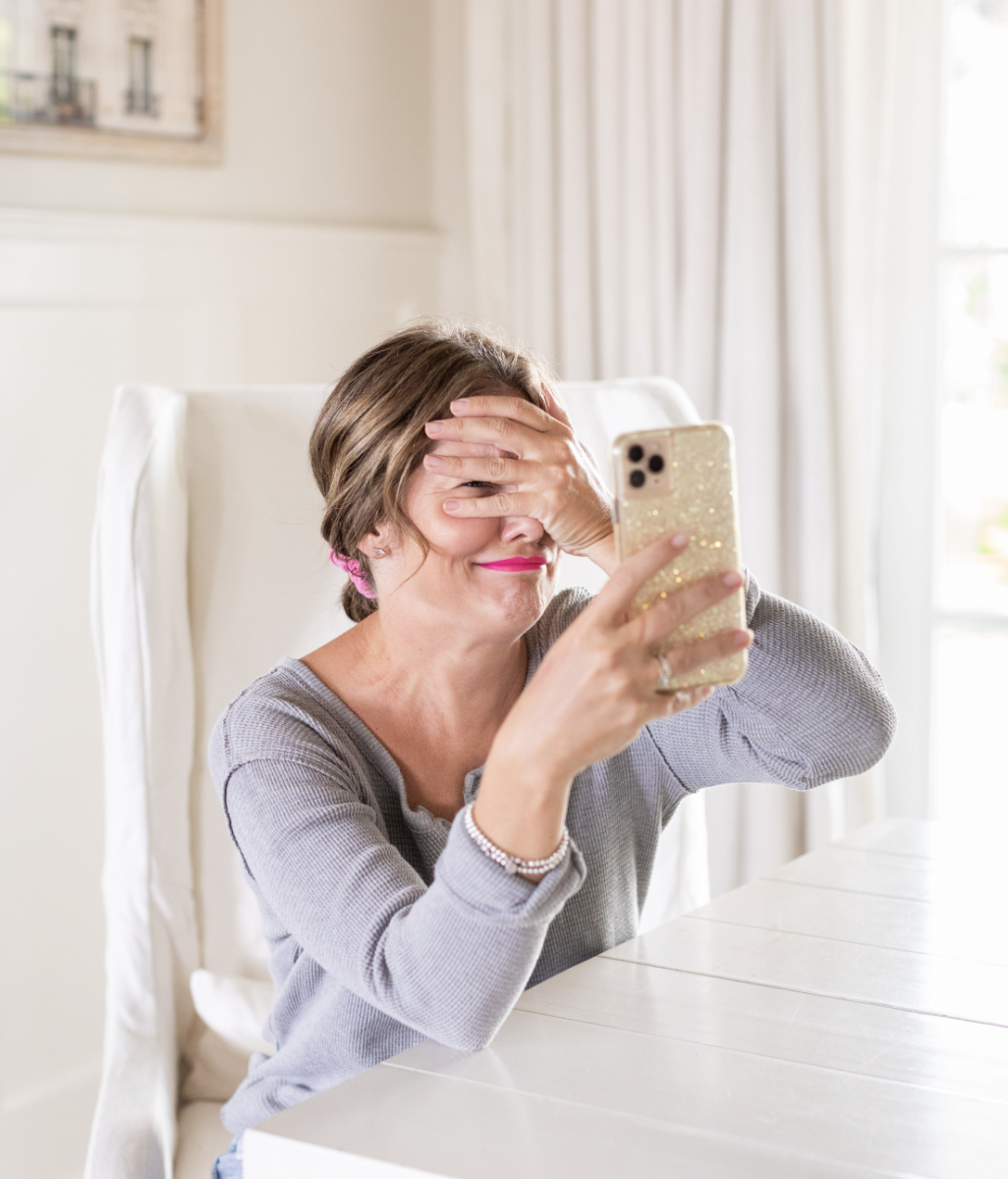 Photo of Jillian Harris looking at phone perplexed