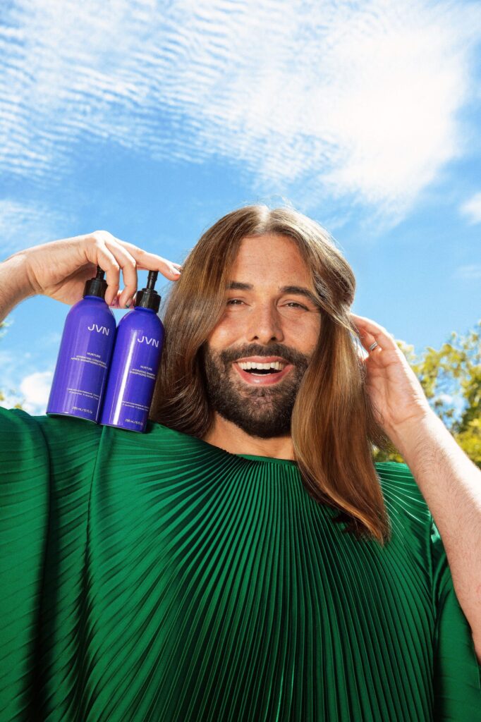 Jonathan Van Ness holding JVN Hair products