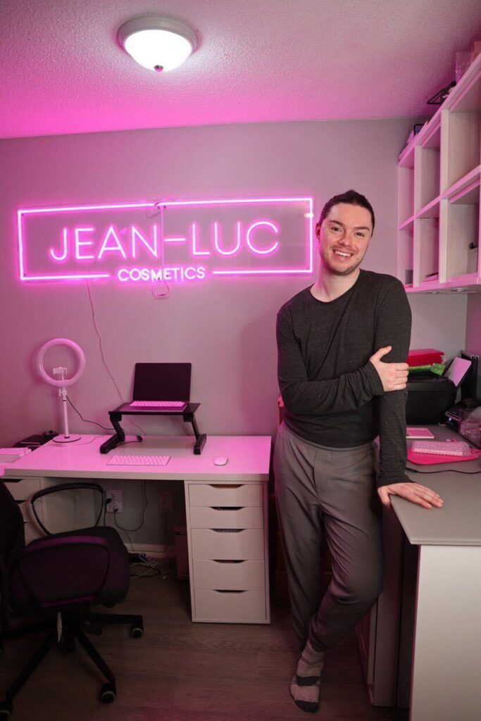 Jean-Luc standing next to Jean-Luc Cosmetic sign