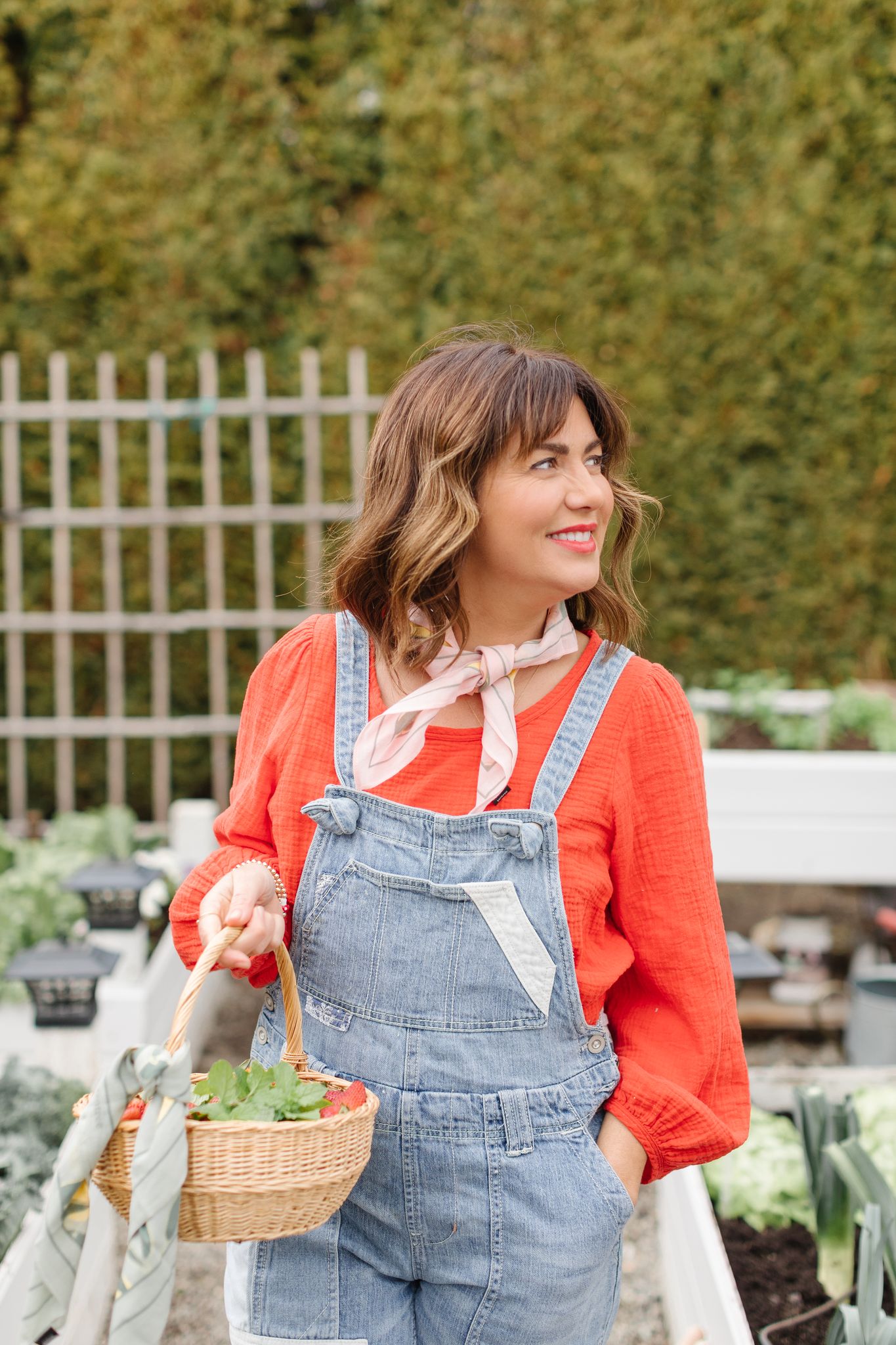 Jillian in her garden with the tentree Jilly Lemon Print Scarf 