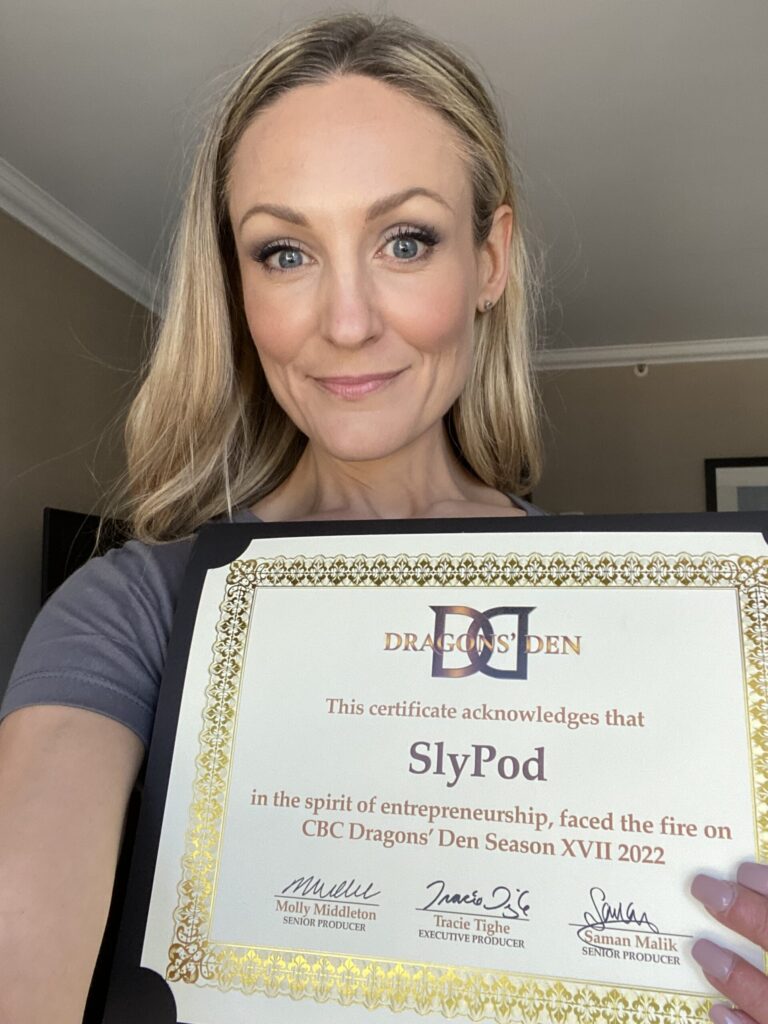 Jilly Academy Alumni member Nicole Duff holding up her certificate from Dragon's Den where she took one of her big risks on, SlyPod.