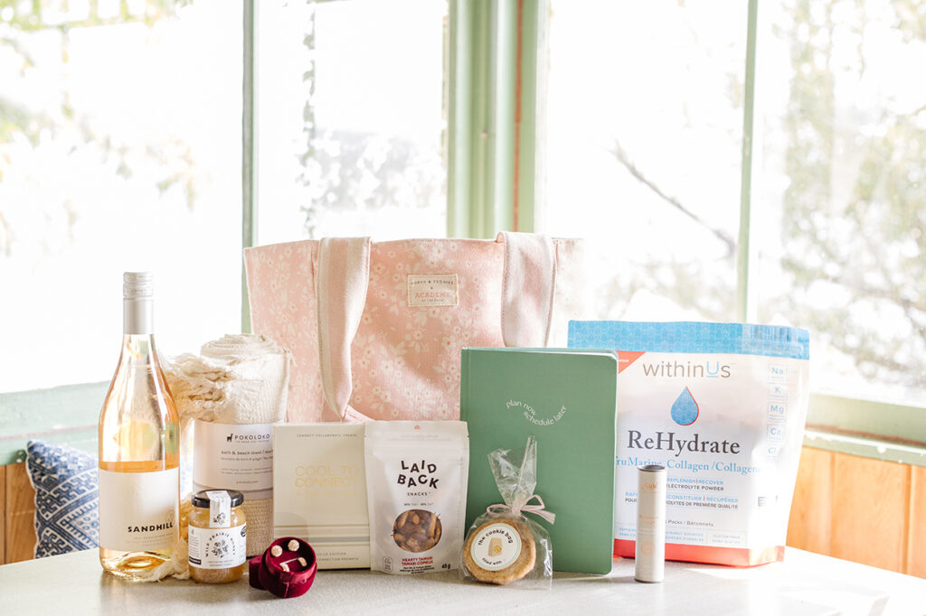 Gift bag items: Poppy and Peonies reversible bag, bottle of Sandhill wine, Pokoloko towel, Wild Priarie honey jar, Hillberg and Berk earrings, Cool to Connect cards, Laidback Snacks, cookie from The Cookie Bag, Later Media planner, Saje Wellness Peppermint roll-on, withinUs ReHydrate.