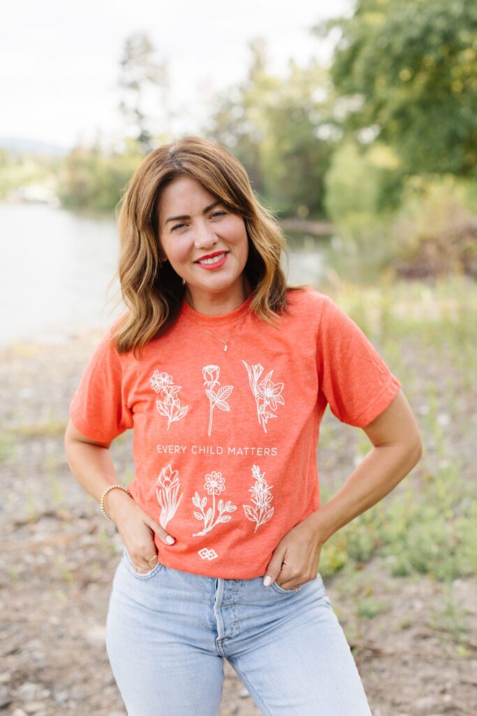 Jillian Harris wearing the Orange Shirt co-designed with Awasis Boutique offered as a Fall 2022 Jilly Box Add-On option