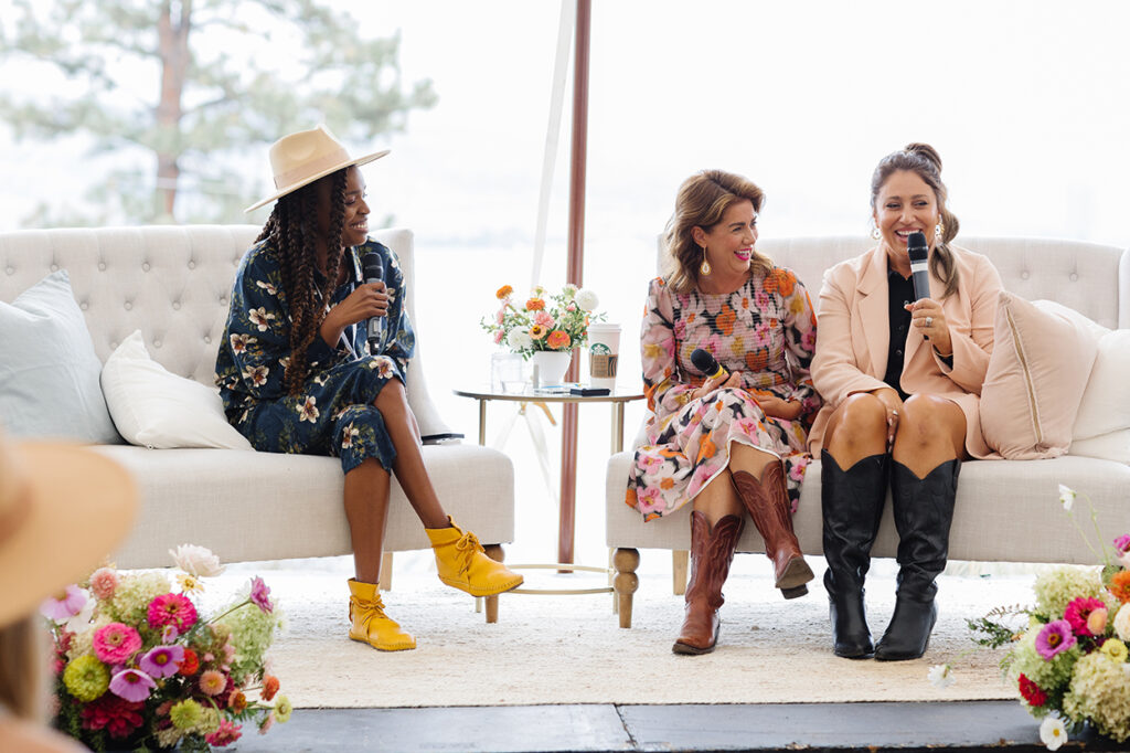 Jam Gamble, Jillian Harris and Ashley Freeborn sitting on couches on the stage at Academy at the Farm.