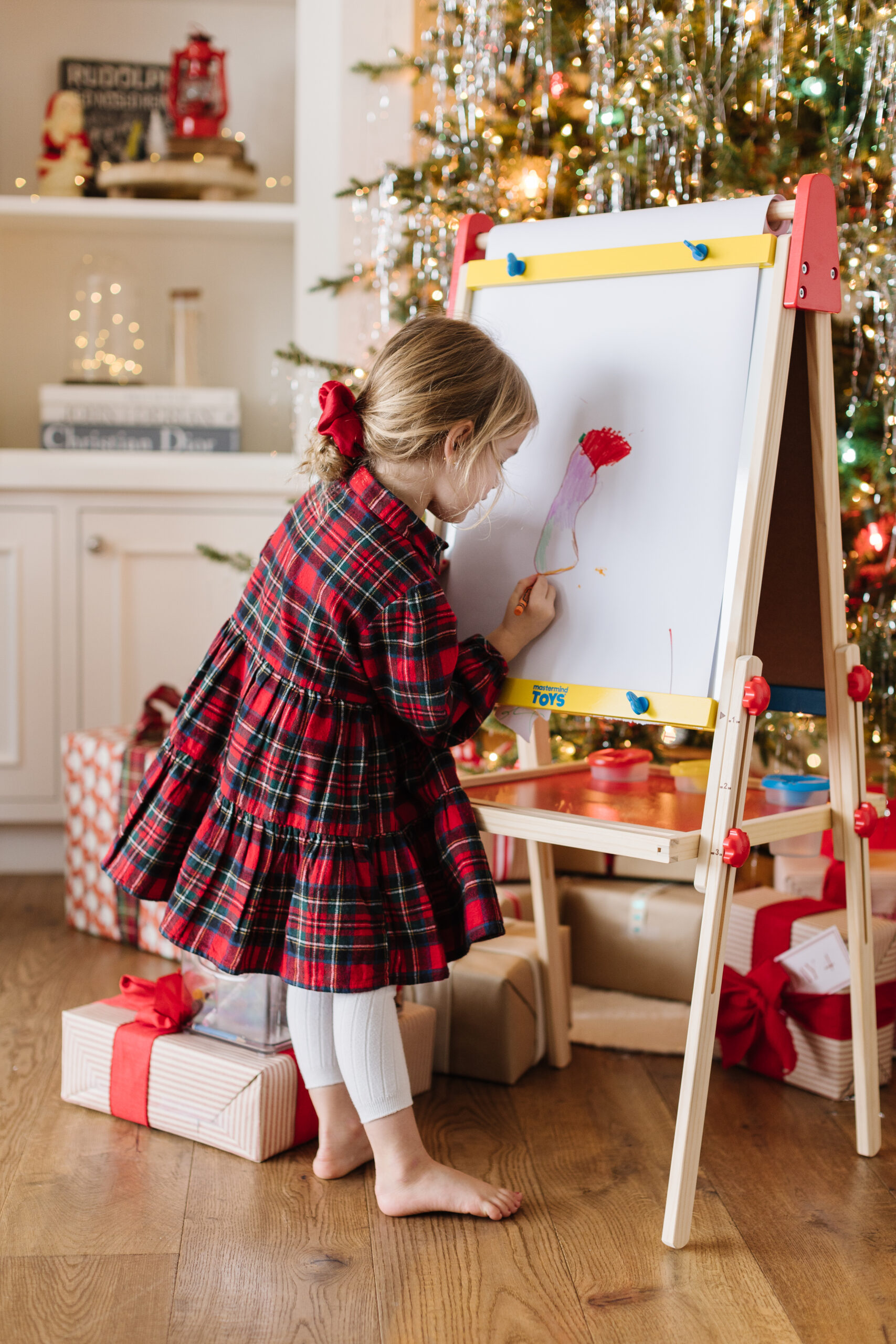 Day 8 Mastermind Toys giveaway Jillian Harris's daughter Annie plays with the Art Easel for the 12 Days of Giving Campaign