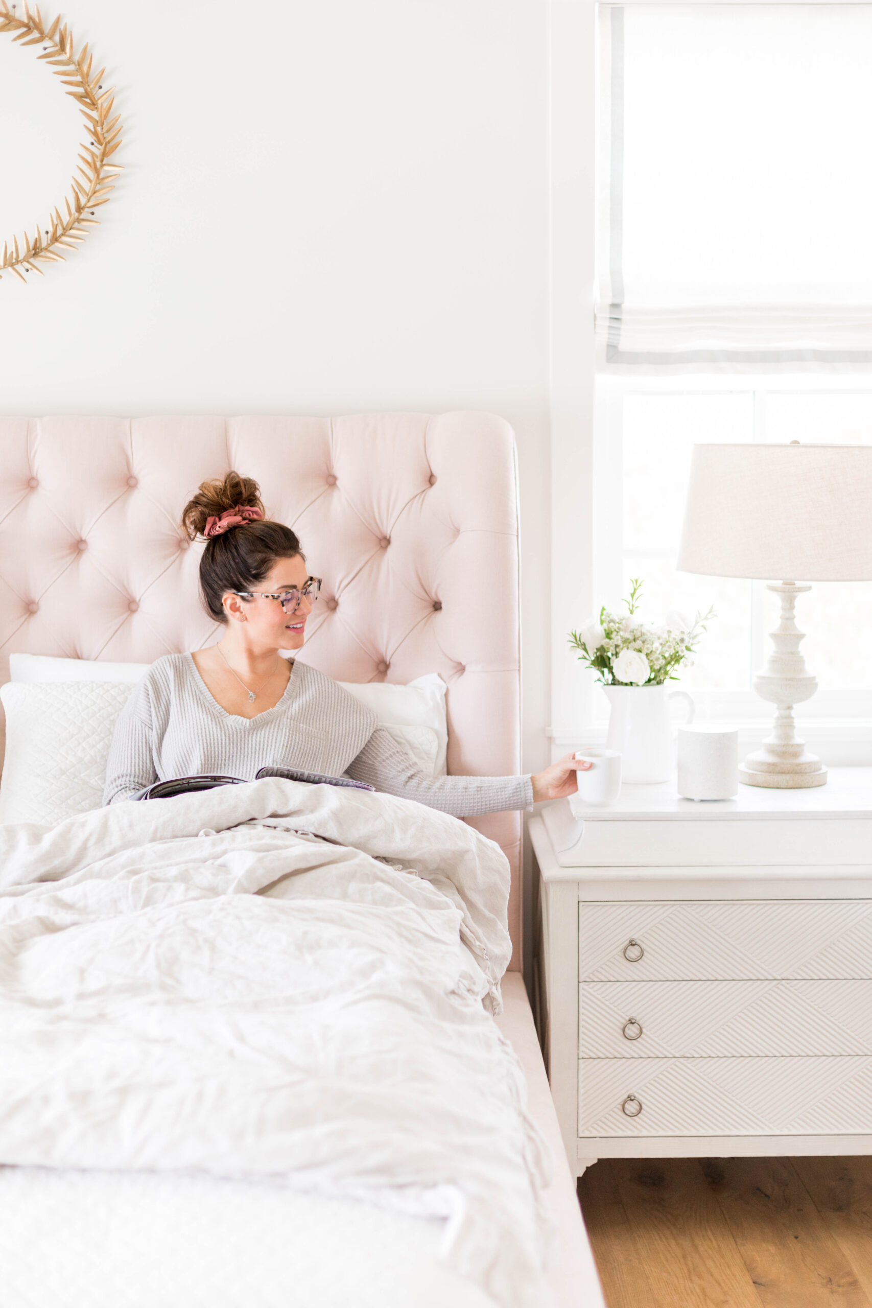 Jillian Harris seated on her iconic pink bed for the Mamas for Mamas bedroom auction