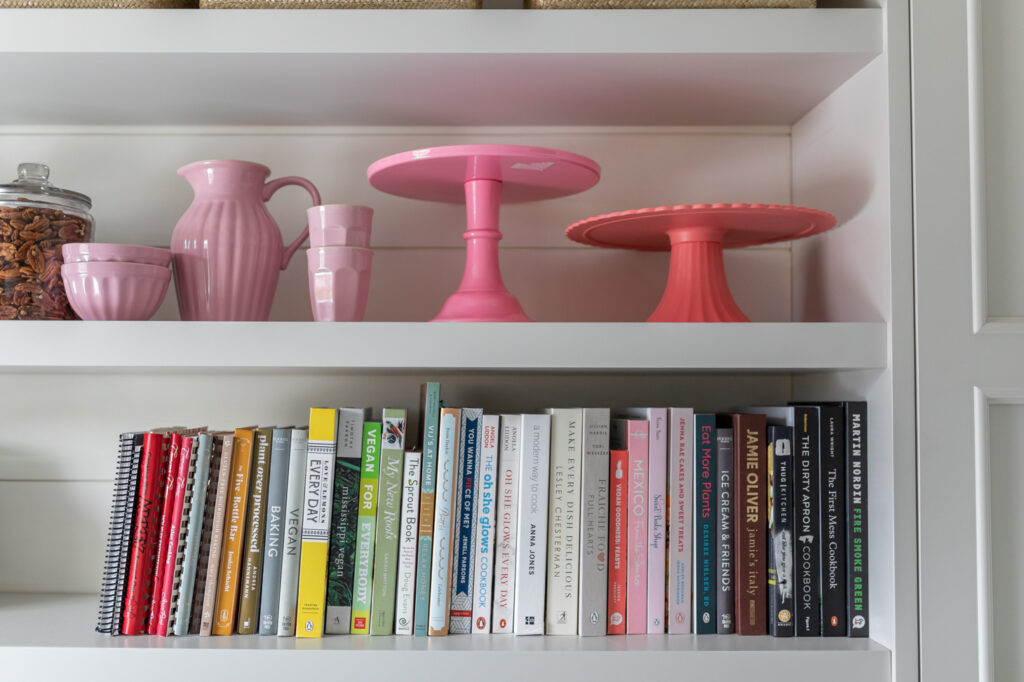 Go Simplified decluttering Jillian Harris's home shelves with books and kitchenware.