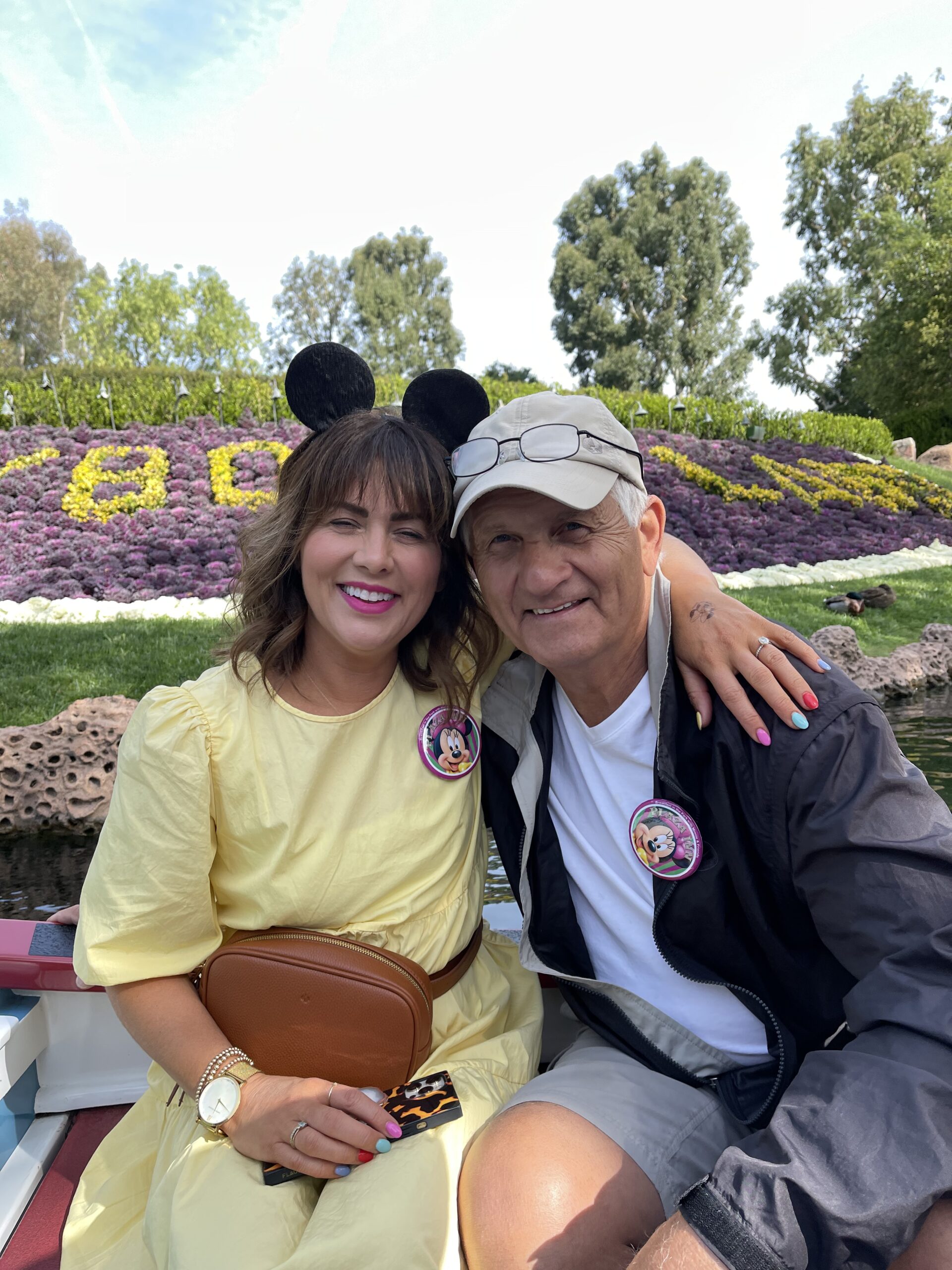 Jillian Harri and her dad wearing Minnie Mouse pins on holiday