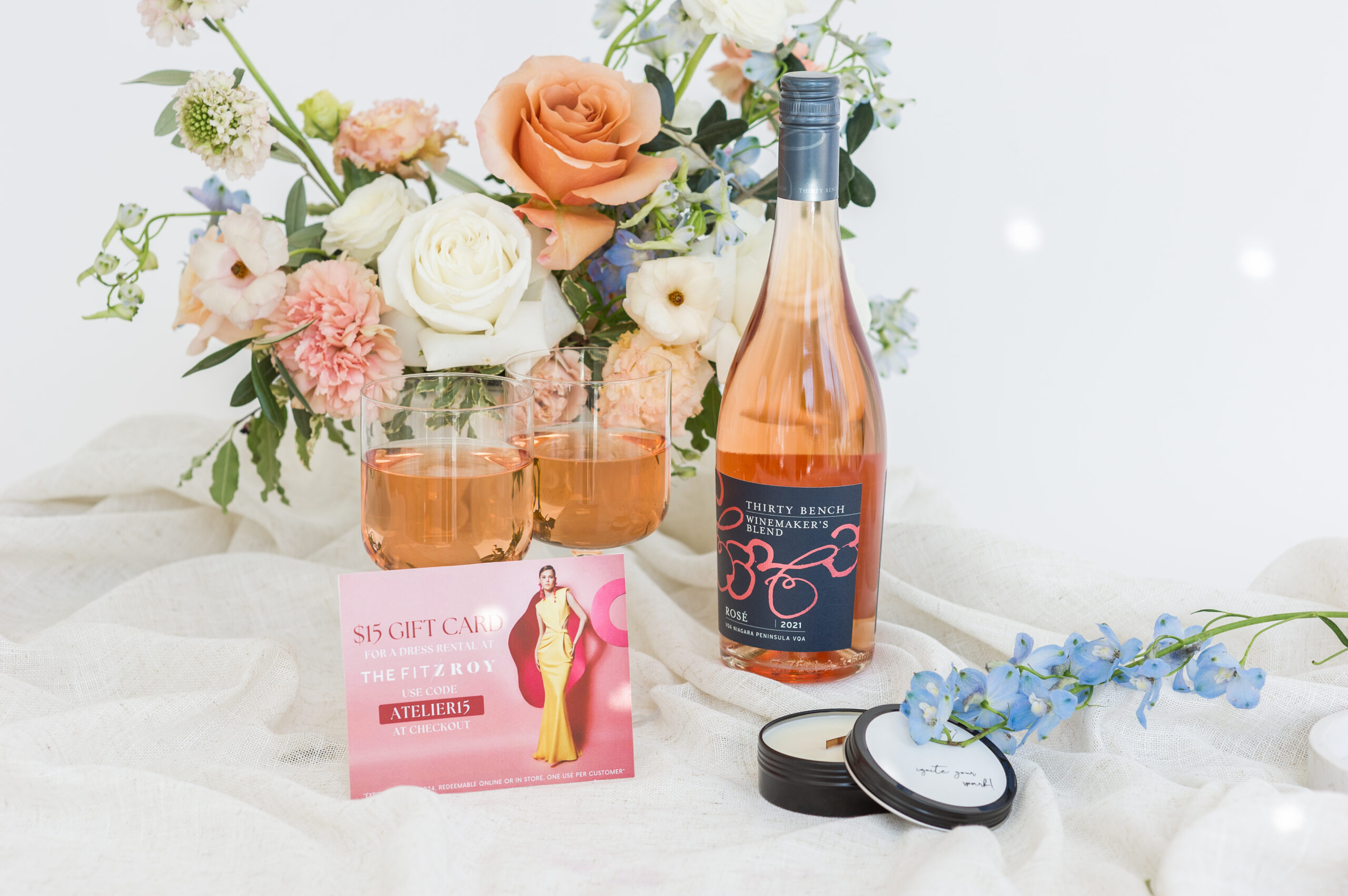 A bottle of rosé, gift card for Fitzroy Dress Rentrals and a Wild Flicker candle.