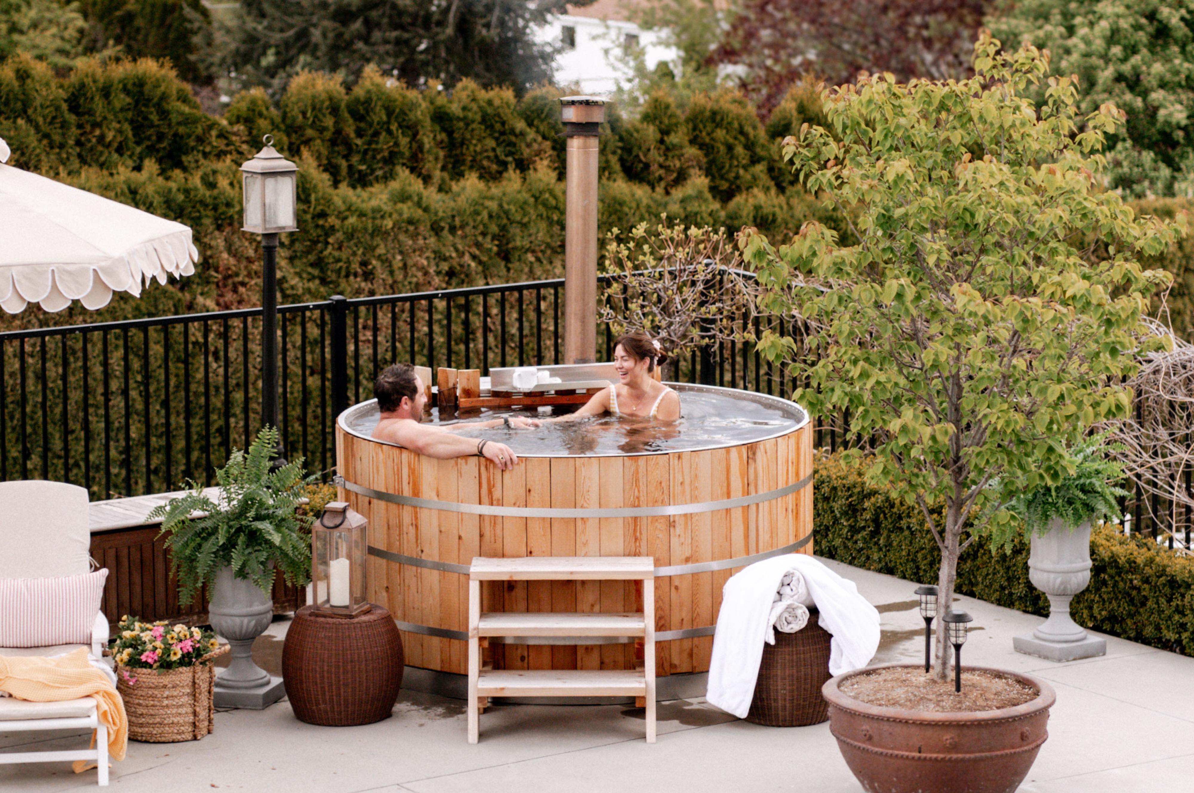 Jillian Harris and Justin Pasutto sitting in the Alumi Tubs Wood Fired Hot Tub