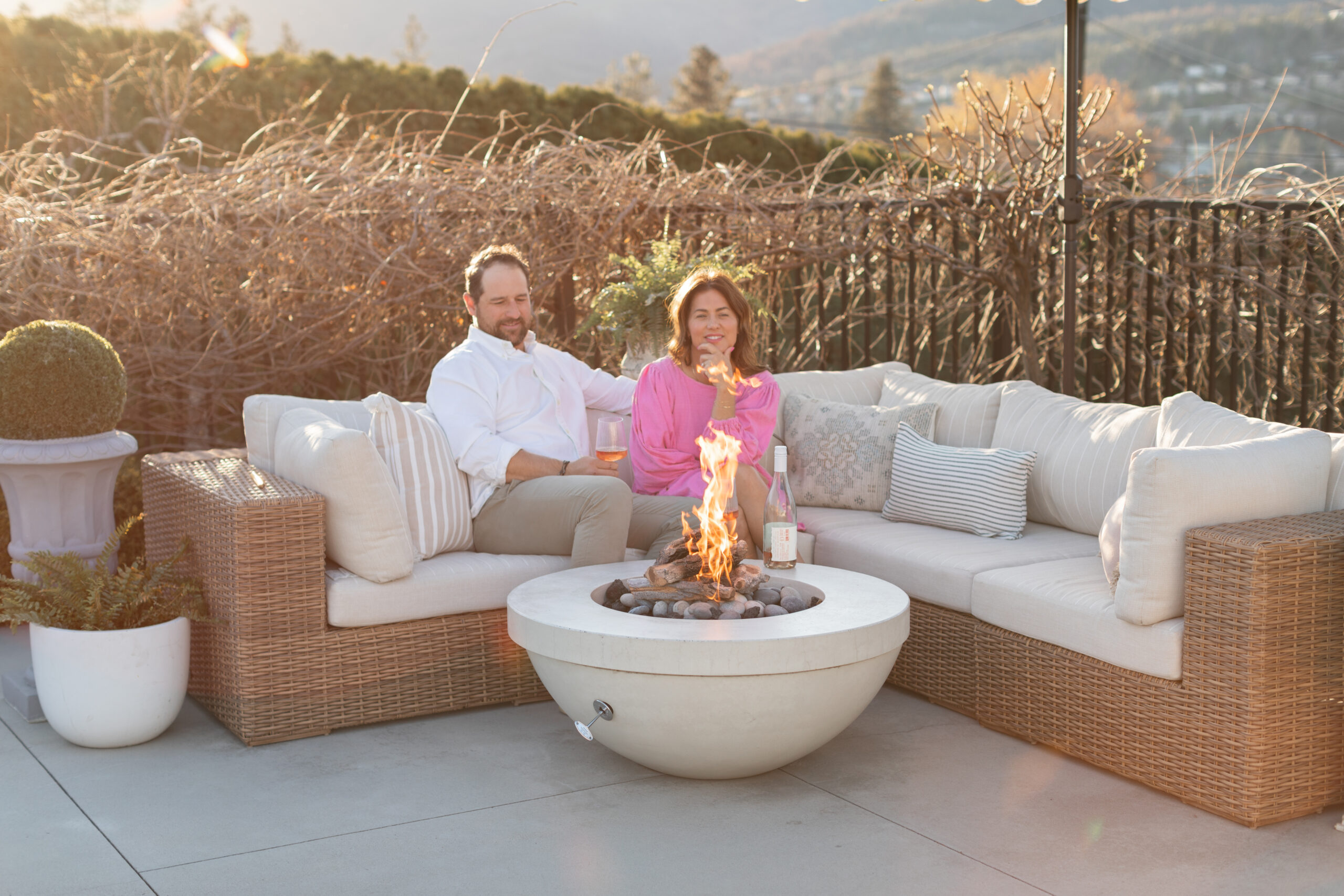 Jillian and Justin sitting on a couch by the Dreamcast outdoor fire pit