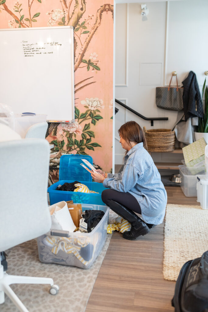 Jillian Harris going through items at The Jilly Box office. 