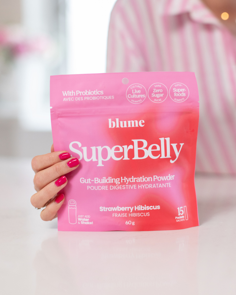 Jillian holding the Blume SuperBelly product in a kitchen. 