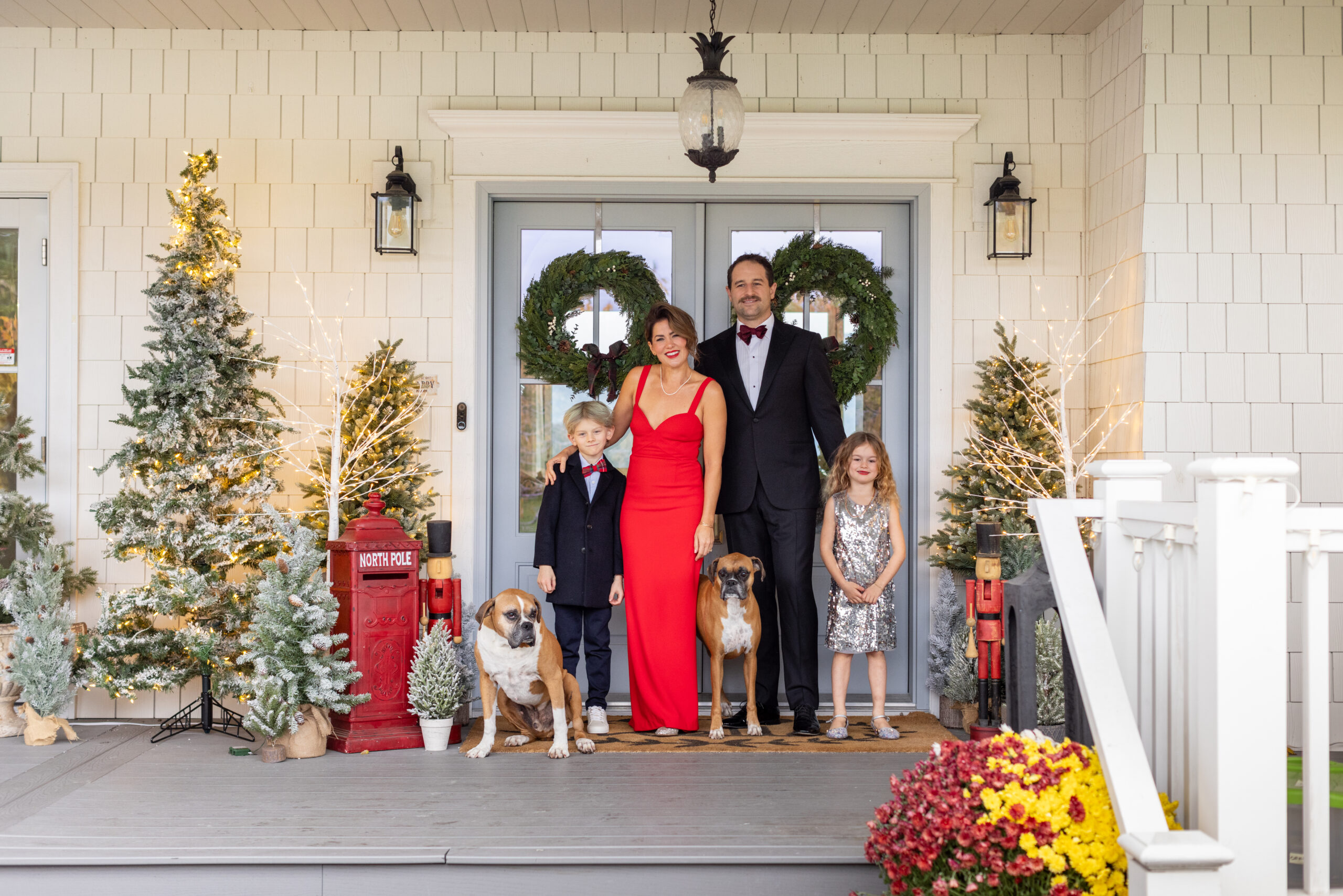 Jillian Harris and family on front porch decorated for the holidays