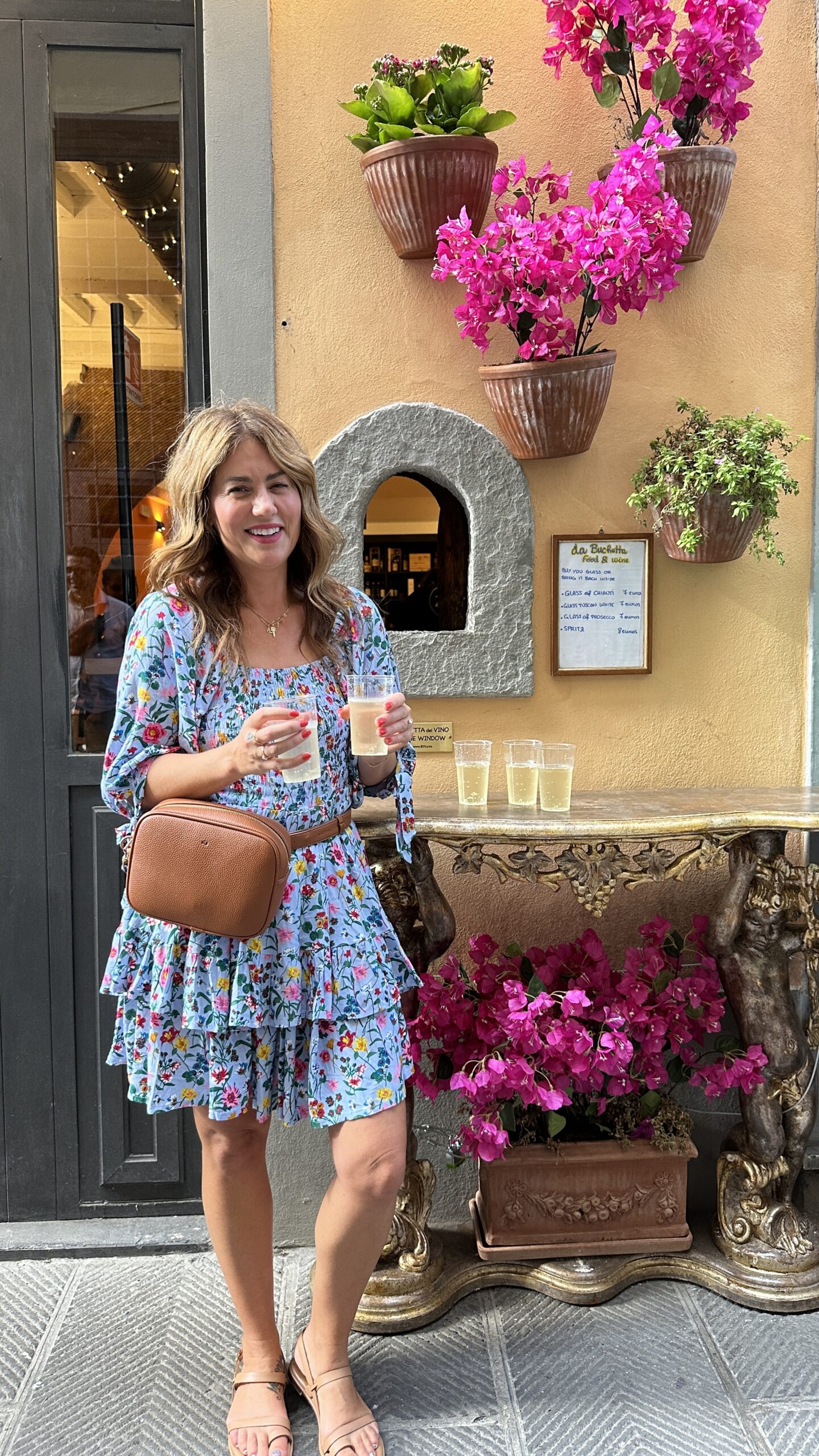 Jillian ordering wine from the wine window in Florence
