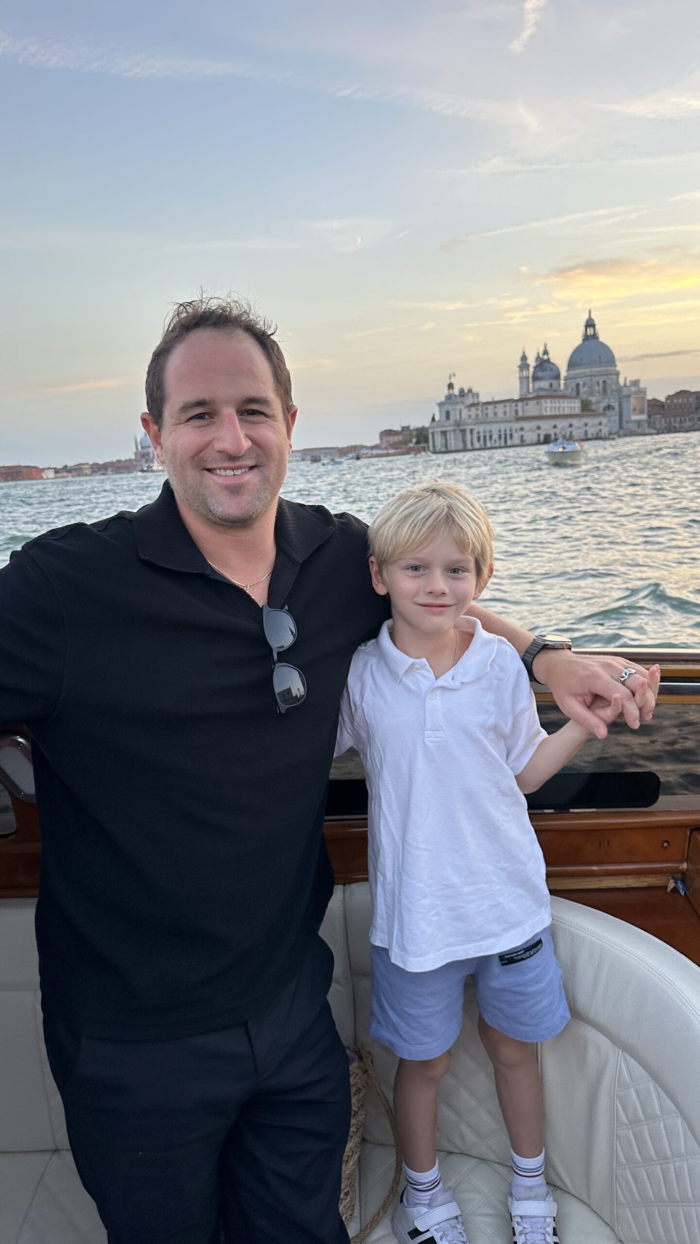 Justin and Leo on a boat in Venice, Italy