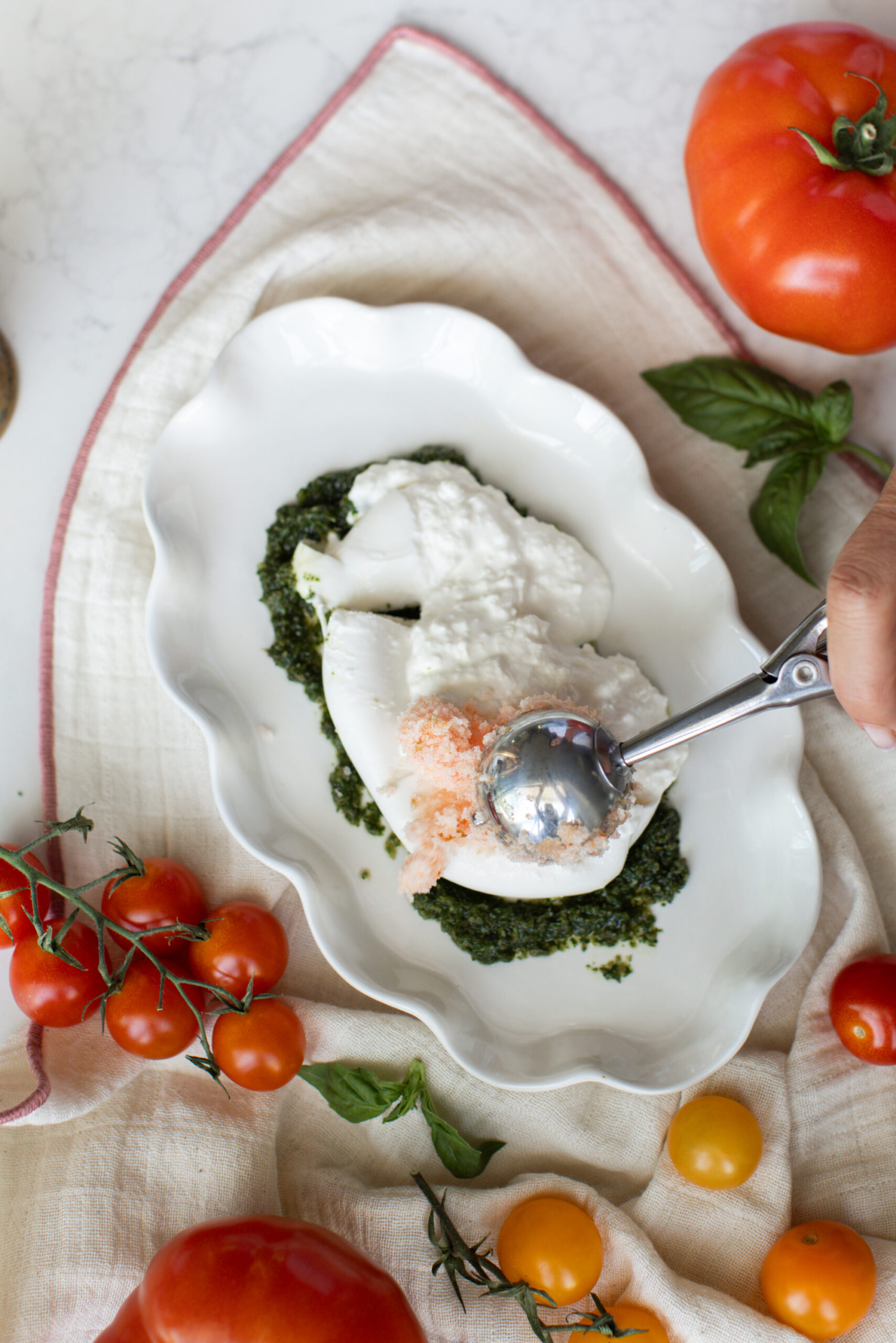 Place the frozen tomato shavings on top of the burrata