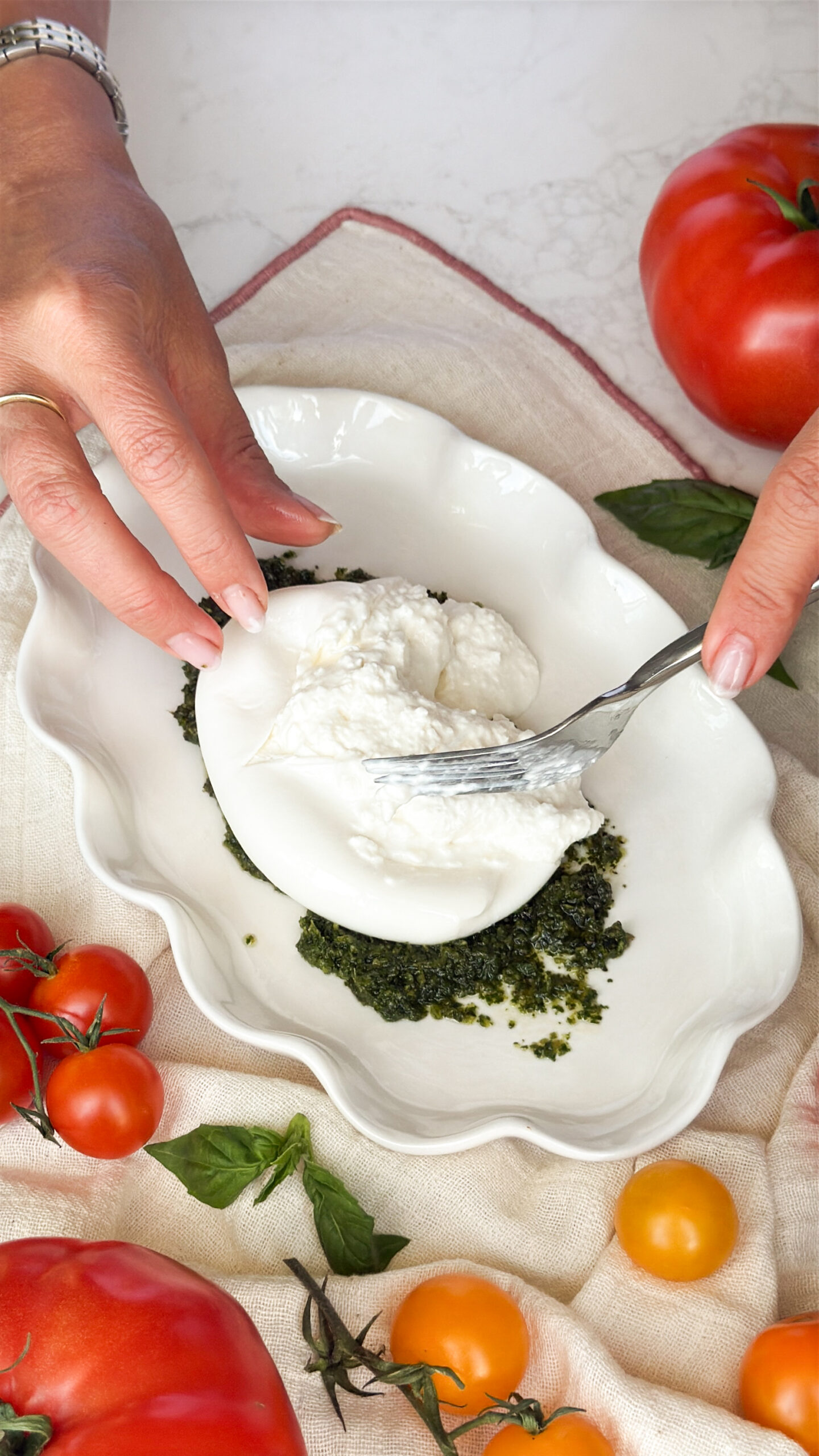 Placing the burrata on top of the pesto