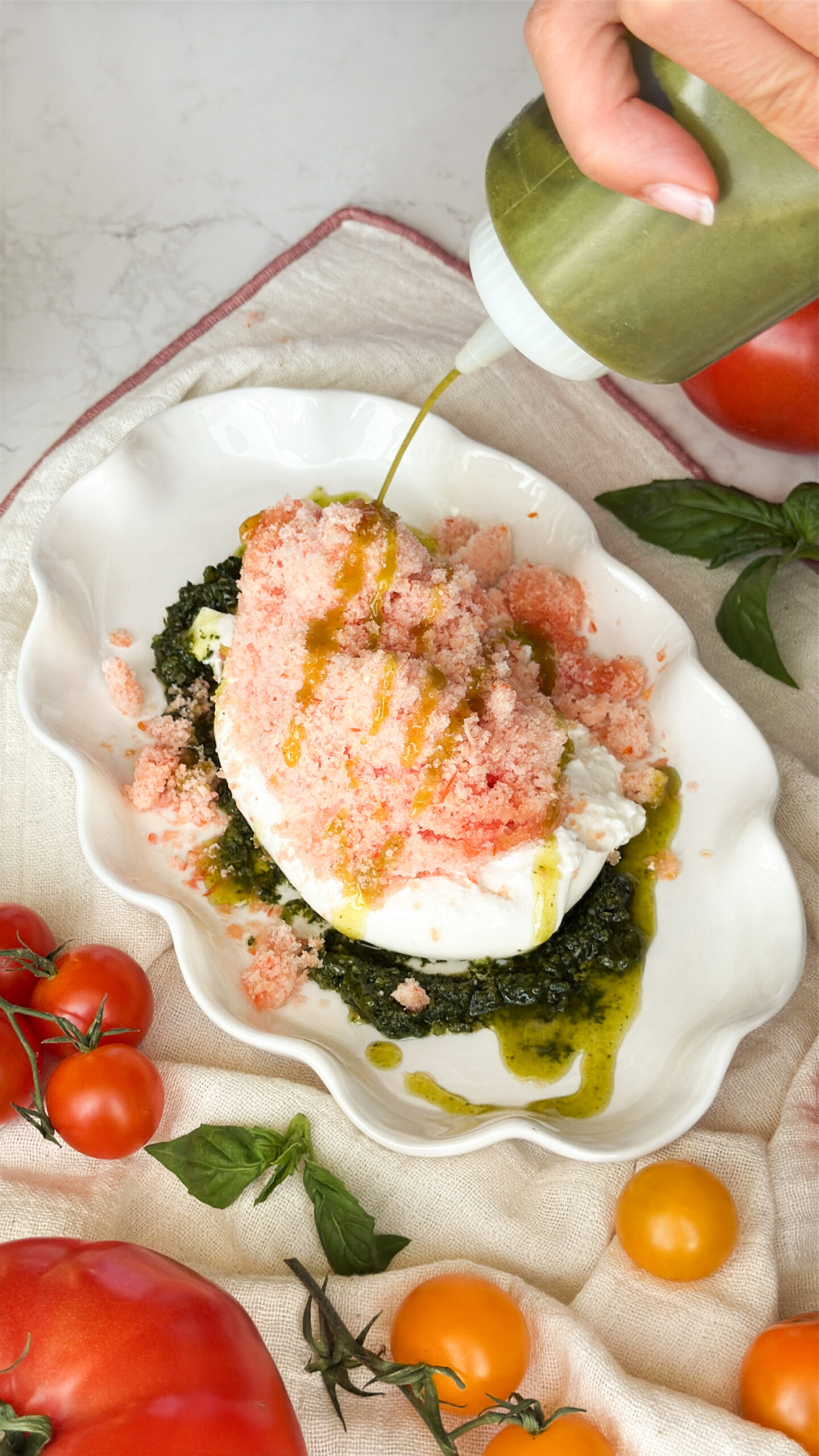 Drizzle basil olive oil on top of the frozen tomato