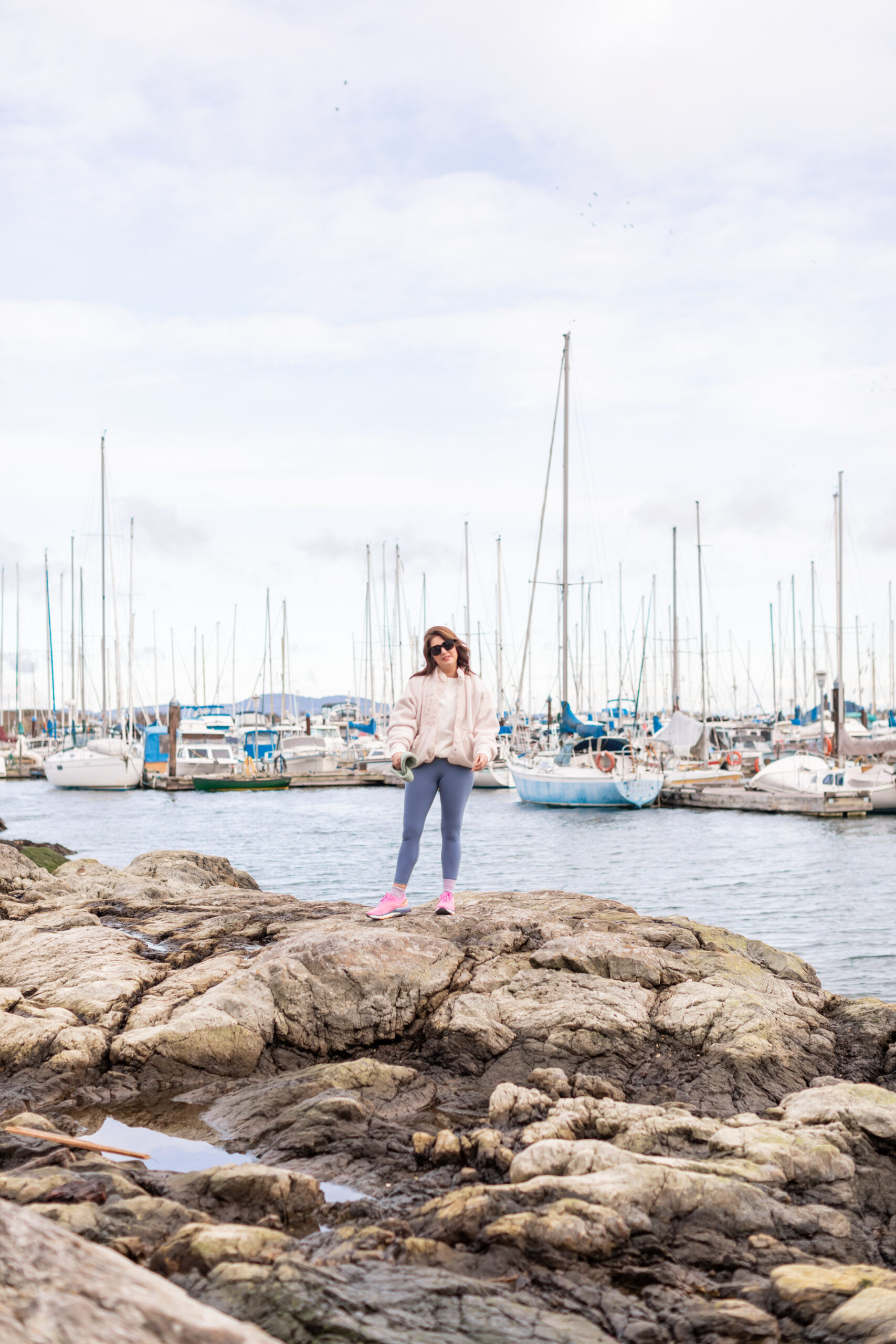 Jillian standing by the sailboats in the Oak Bay Marina