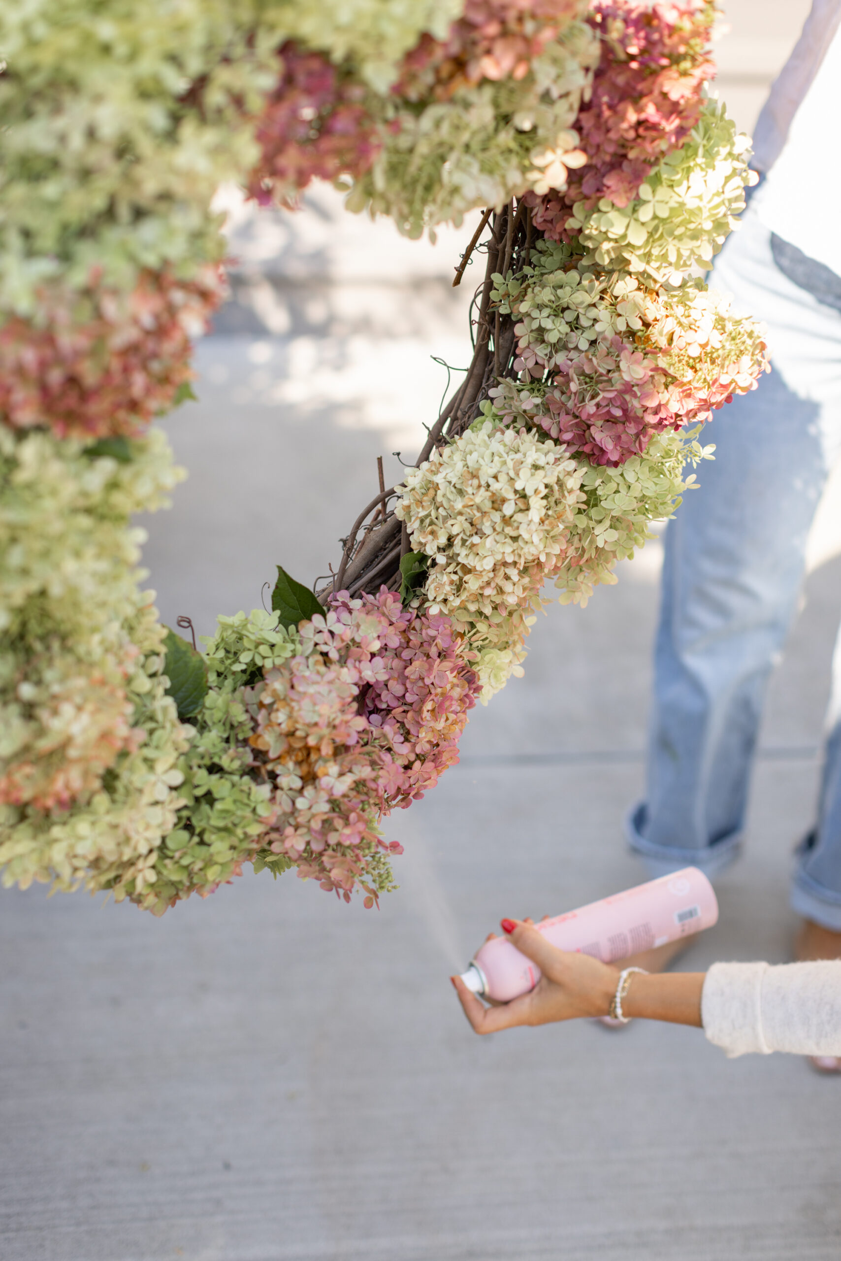 hair spraying the dried hydrangea wreath
