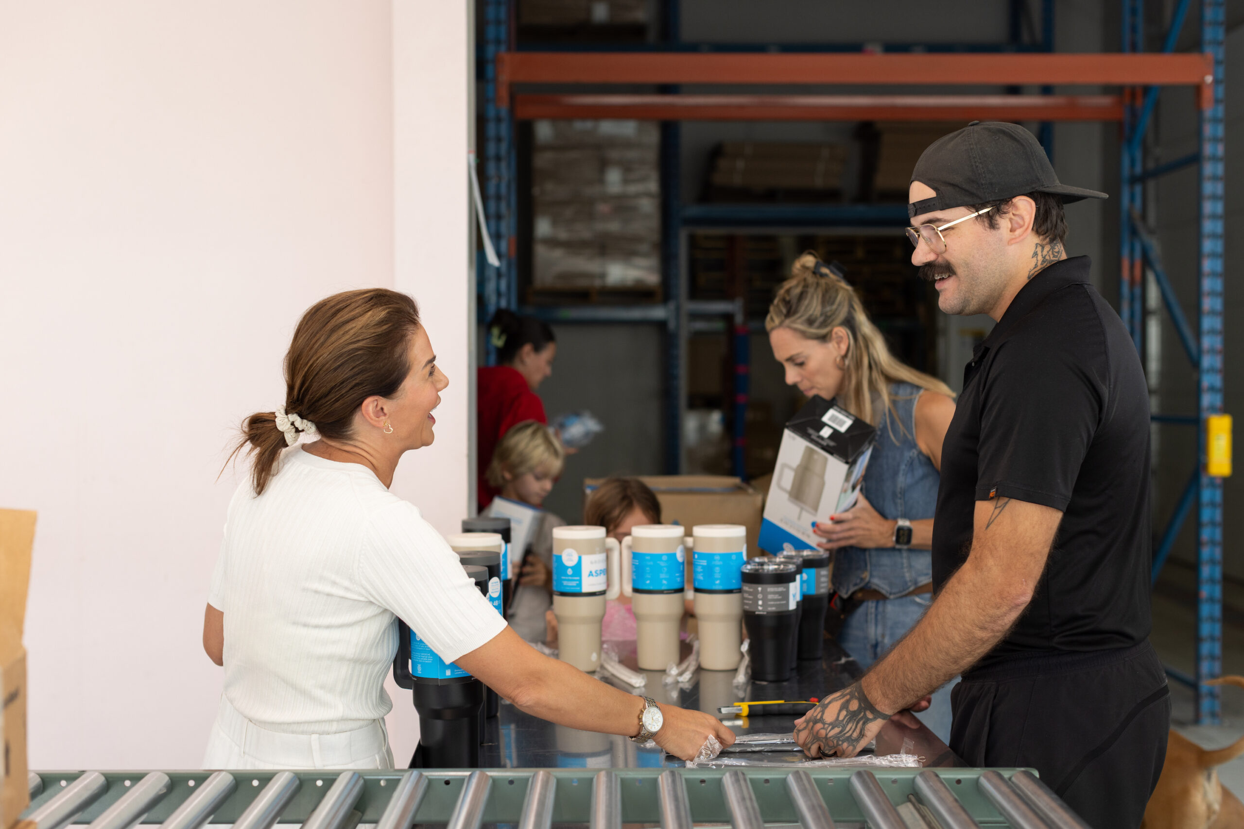 Jillian Harris and the Locality team packing the wedding welcome boxes, featuring the Grosche Aspen Tumbler