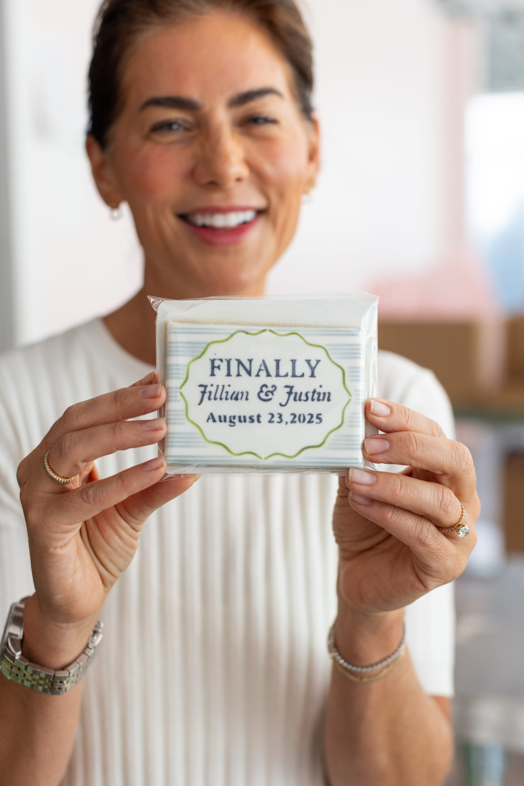 Jillian Harris holding a cookie from Love and Flour Bakery in Kelowna.